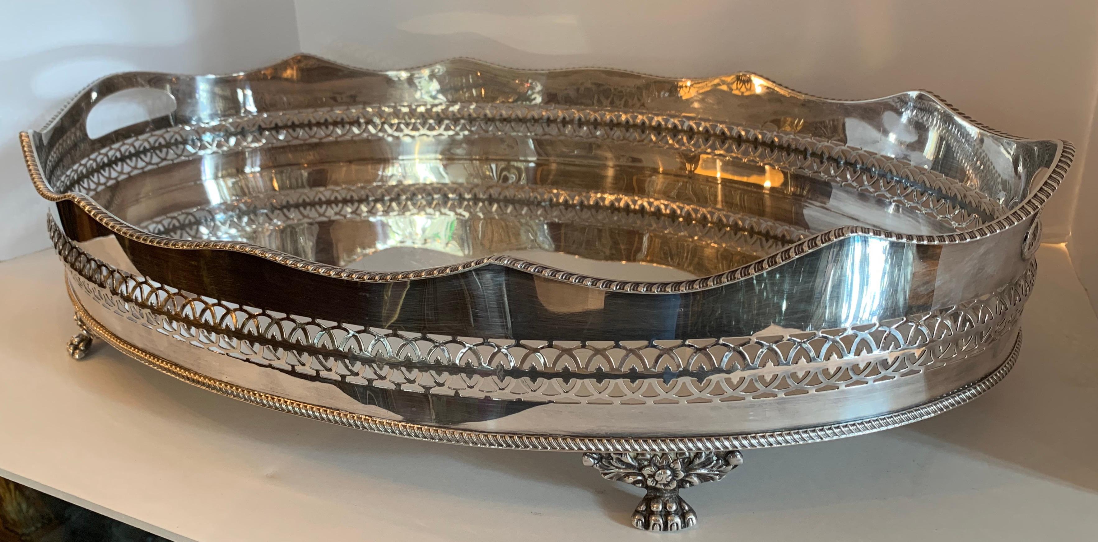 A vintage English Sheffield style silver plated over copper footed barware / serving gallery pierced oval tray.