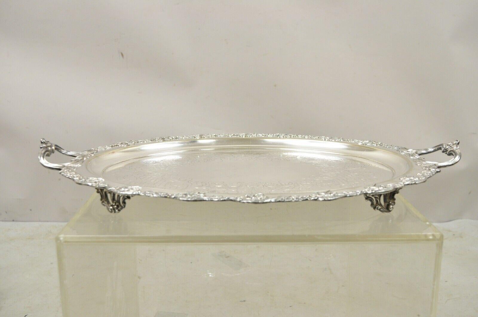 Vintage English Sheffield Silver Plated Oval Maple Leaf Serving Platter Tray. Item features ornate Twin Handles, Etched Center, Maple Leaf Gallery, Original Hallmark, Raised on Ornate Feet. Circa Mid 20th Century. Measurements:  2
