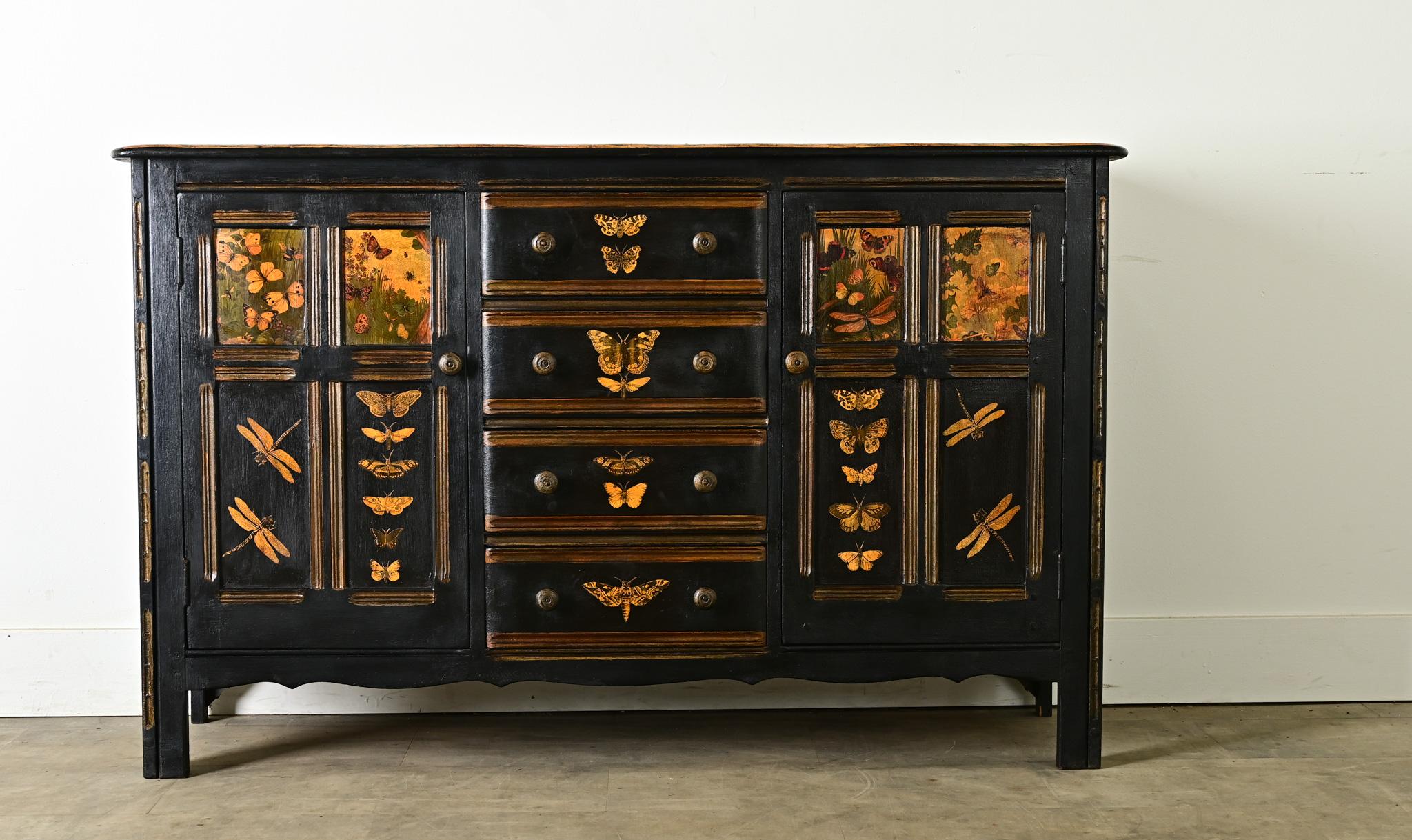 This vintage English sideboard has been given a new look with recent ebonized (painted) and decoupage finish over solid wood construction. The smooth, rounded top surface is alive with illustrations of flowering bulb plants and butterflies framed by