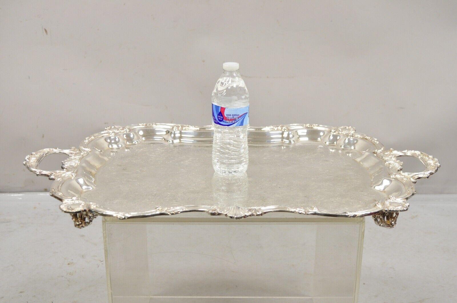 Vintage English Silver Mfg Corp Large Silver Plated Etched Platter Tray. Item features ornate floral scrollwork etching, raised on feet, fancy twin handles, original hallmark. Circa Early to Mid 20th Century. Measurements:  2