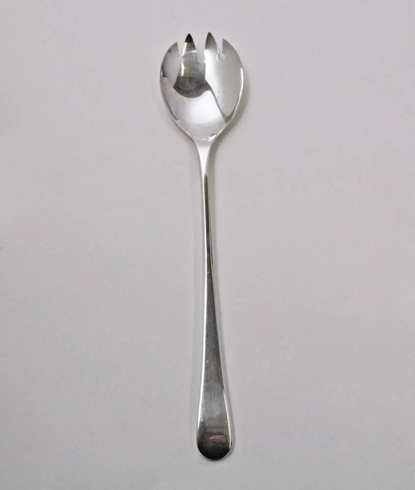 The vintage English silver plated salad serving fork has a long handle and is stamped Elport, Sheffield, England. Classic English Georgian style.