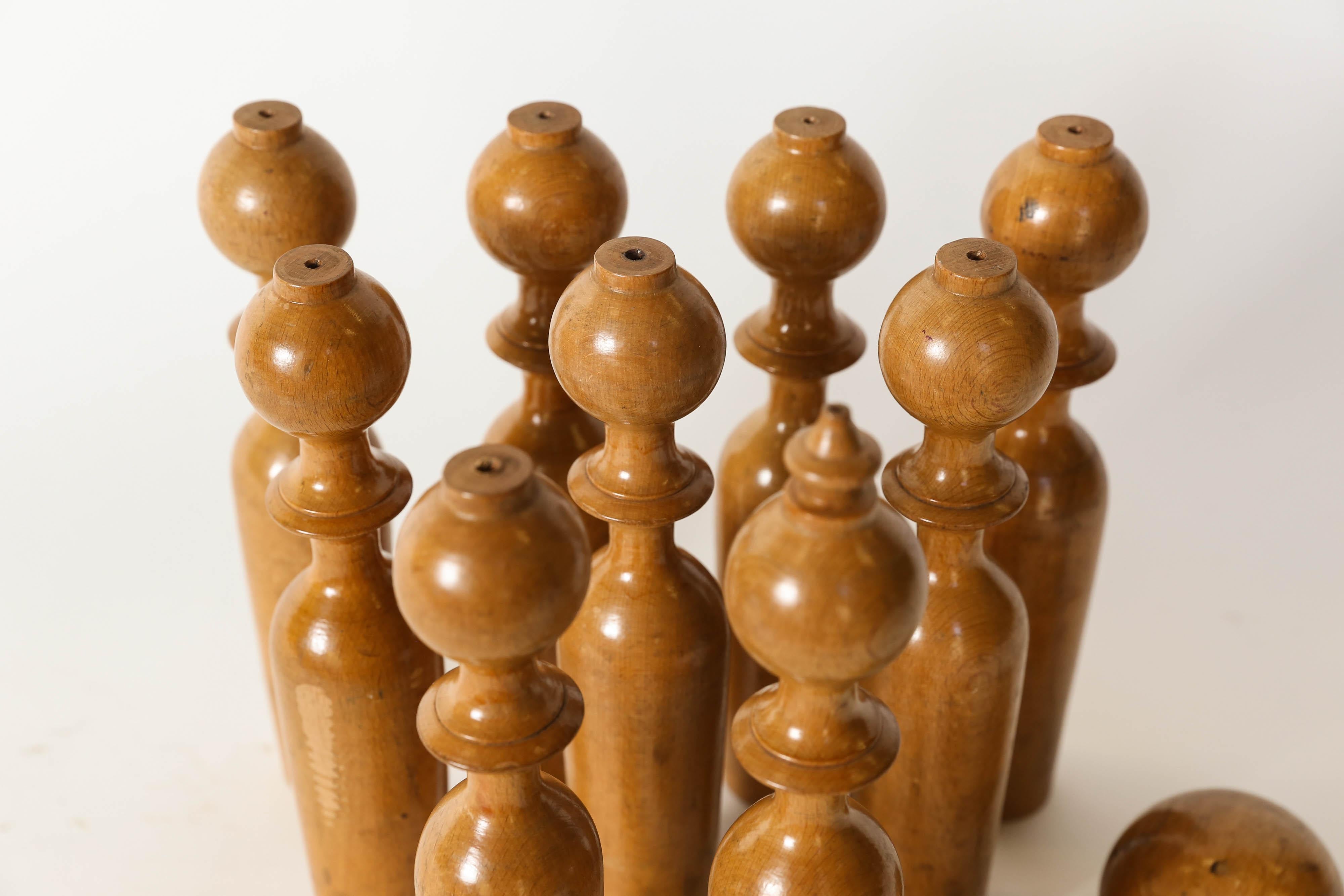 This complete set of nine skittles and two bowling balls from the late 20th century was found in England. The set is made up of eight skittles measuring 9