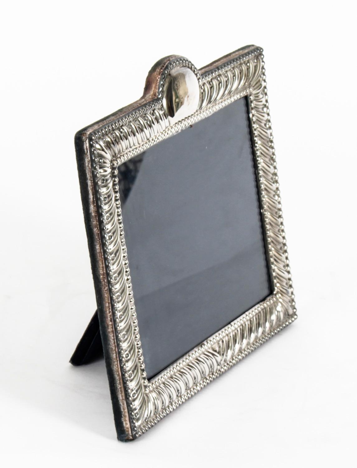 A truly superb vintage sterling silver photo frame bearing the makers mark of Carrs of Sheffield and hallmarks for Sheffield 1986.

The vertical frame has a black velvet back with rectangular border decorated with fluted floral design with beaded