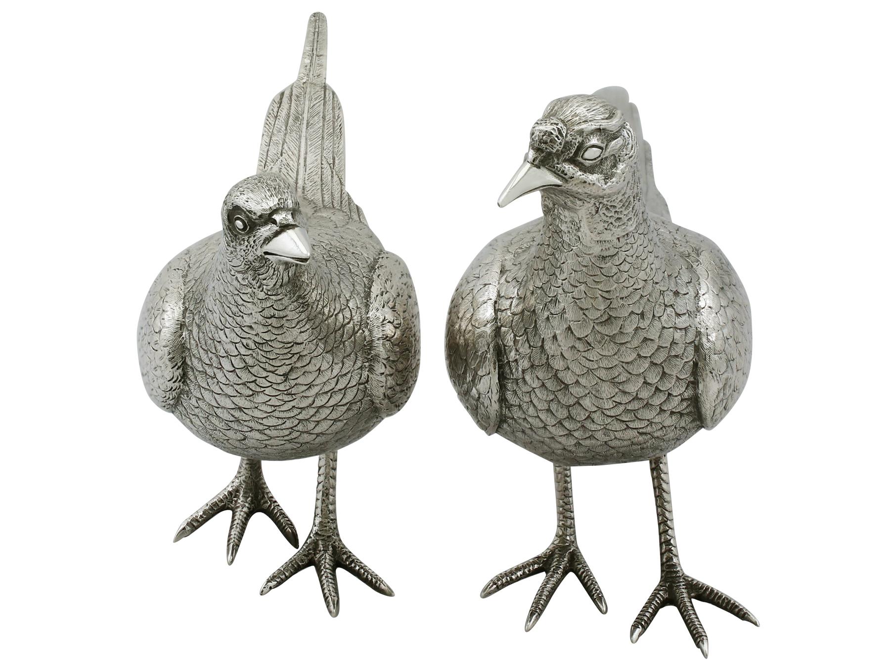 An exceptional, fine and impressive pair of vintage English sterling silver table pheasants; part of our ornamental silverware collection.

These exceptional vintage cast sterling silver table ornaments have been realistically modelled in the form