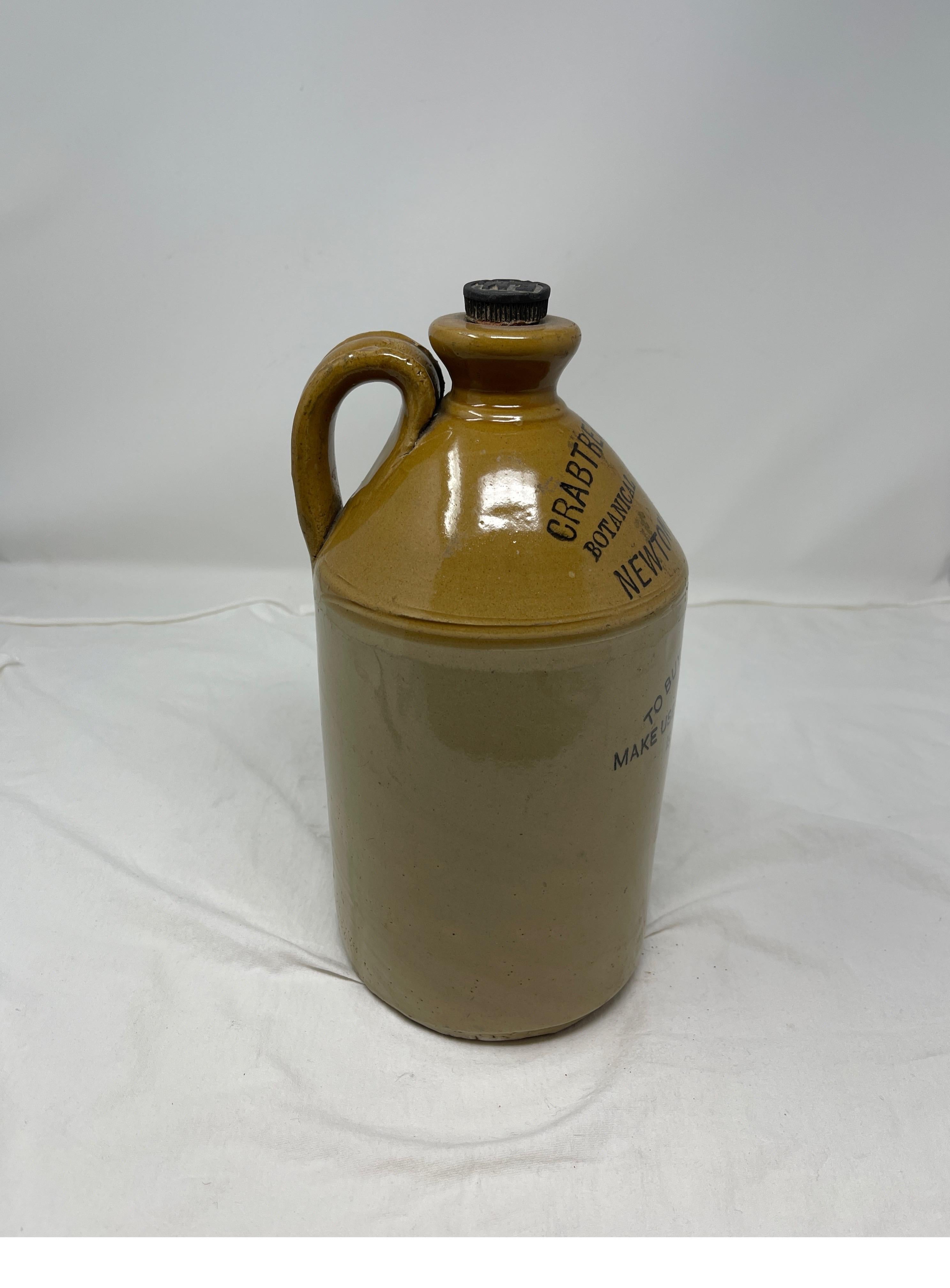 Hand-thrown English glazed two-tone stoneware used for spirits, liquor, or wine pottery jugs with handles. This jug is marked 
