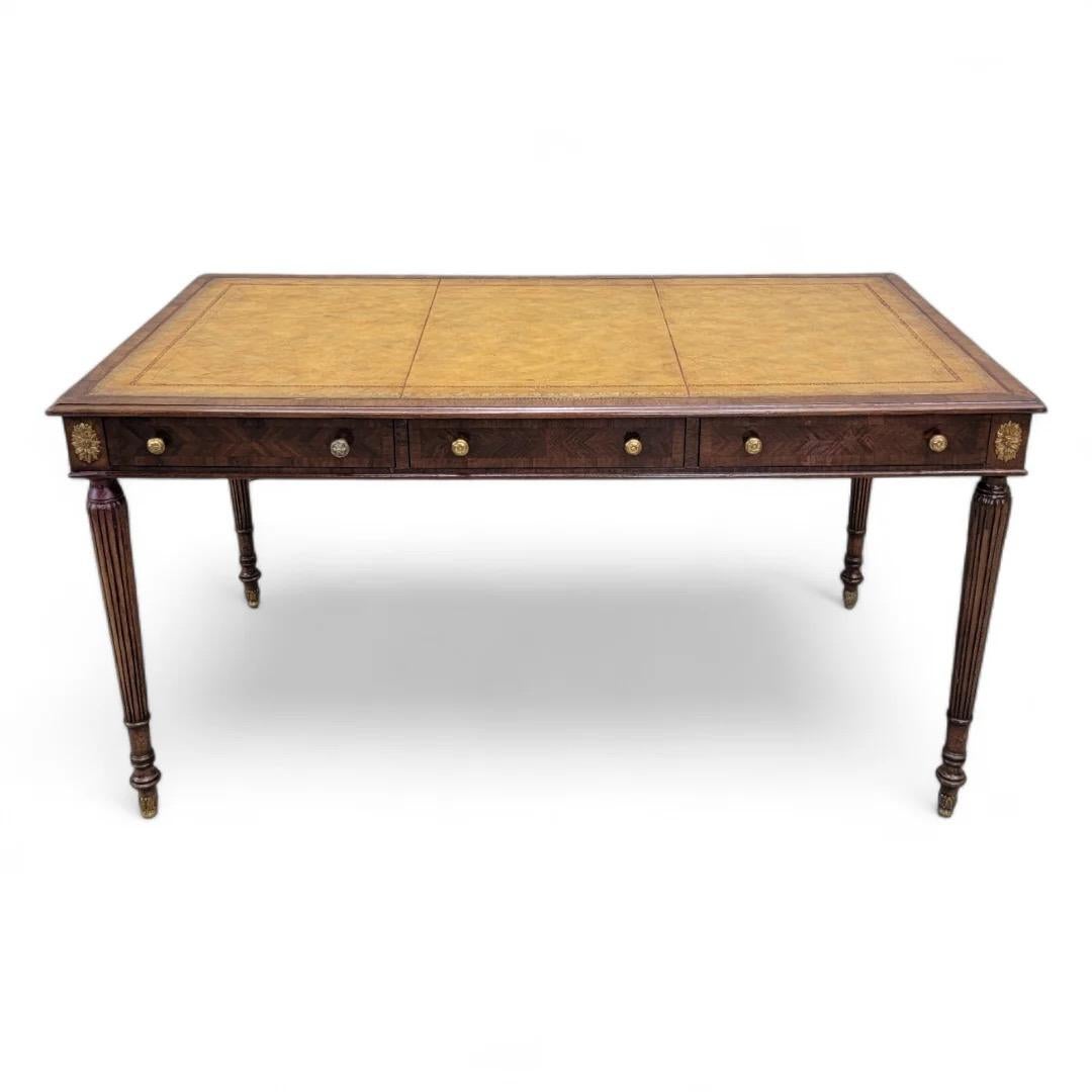 Vintage English Style Mahogany Tooled Leather Top Writing Desk by Maitland Smith

Featuring a vintage mahogany English style writing desk by Maitland Smith with 3 drawers and brass hardware. The tooled leather top adds a touch of sophistication,