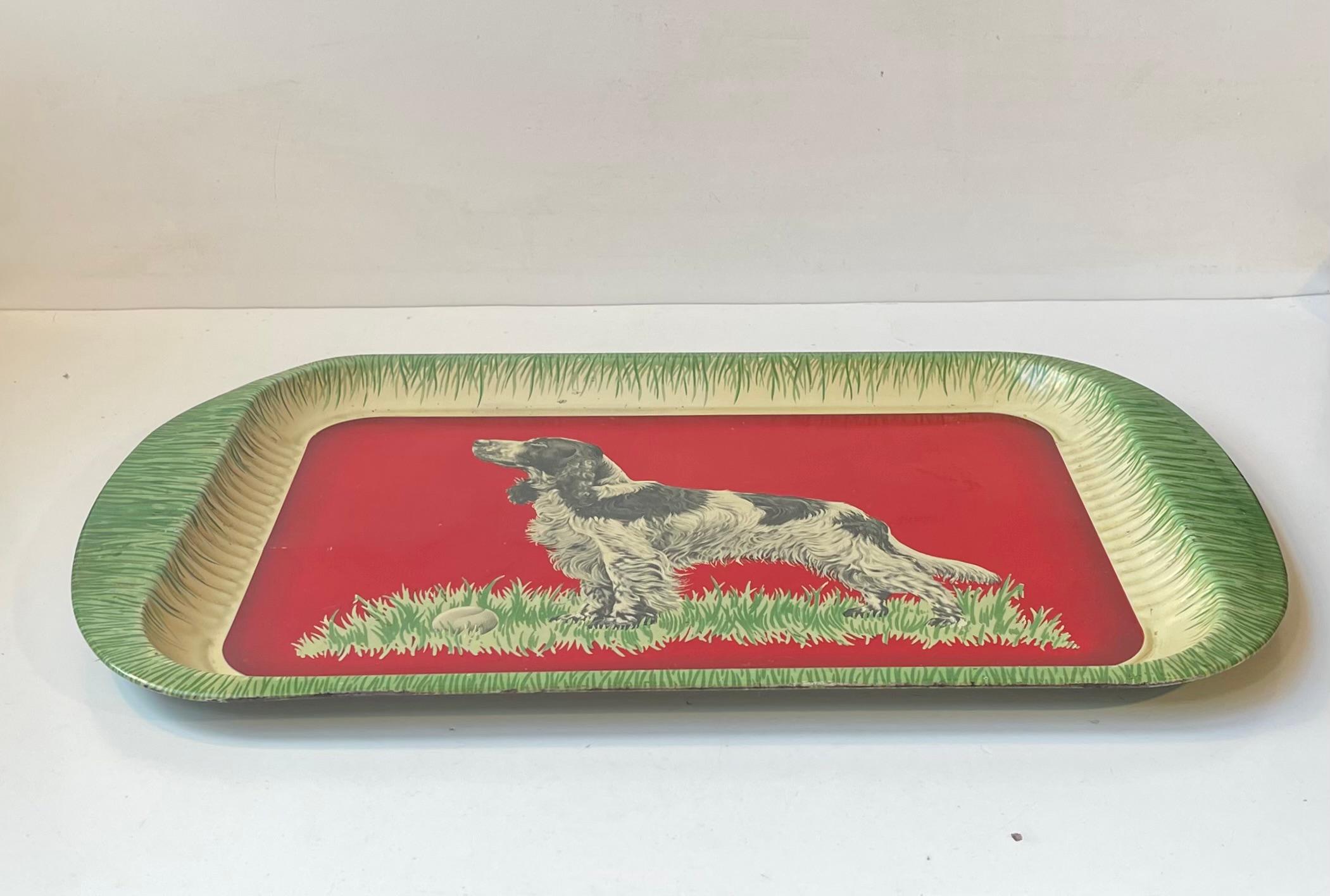 A 1950s tin-plate kitsch serving tray celebrating the beauty of a Springer Spaniel. This is design number 582 made by Handiware in England circa 1950-60. Makers mark present beneath the transfer-printed motif. Measurements: W/L: 47 cm, Dept: 31 cm,