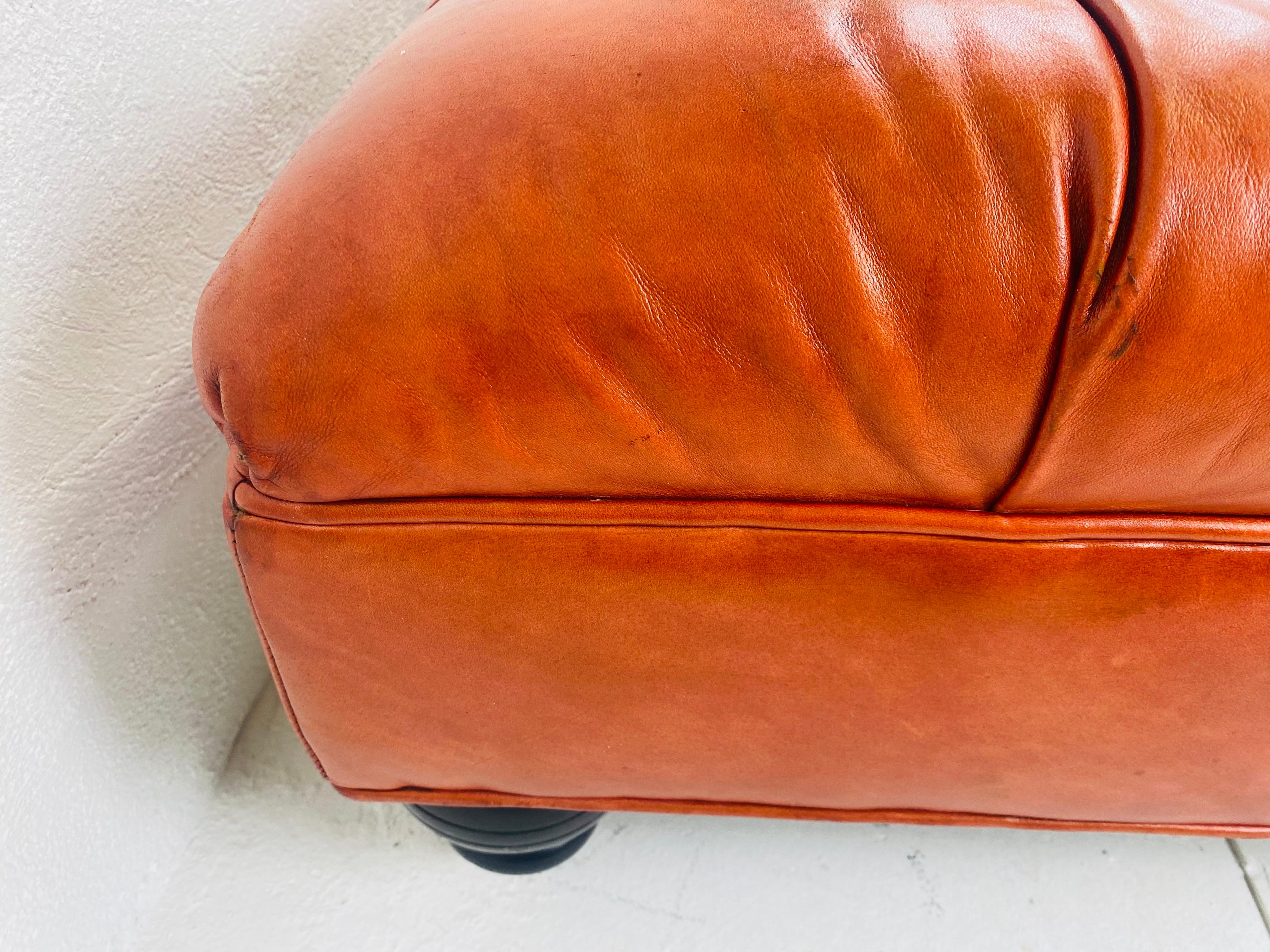 Leather Vintage English traditional style tufted leather ottoman. For Sale