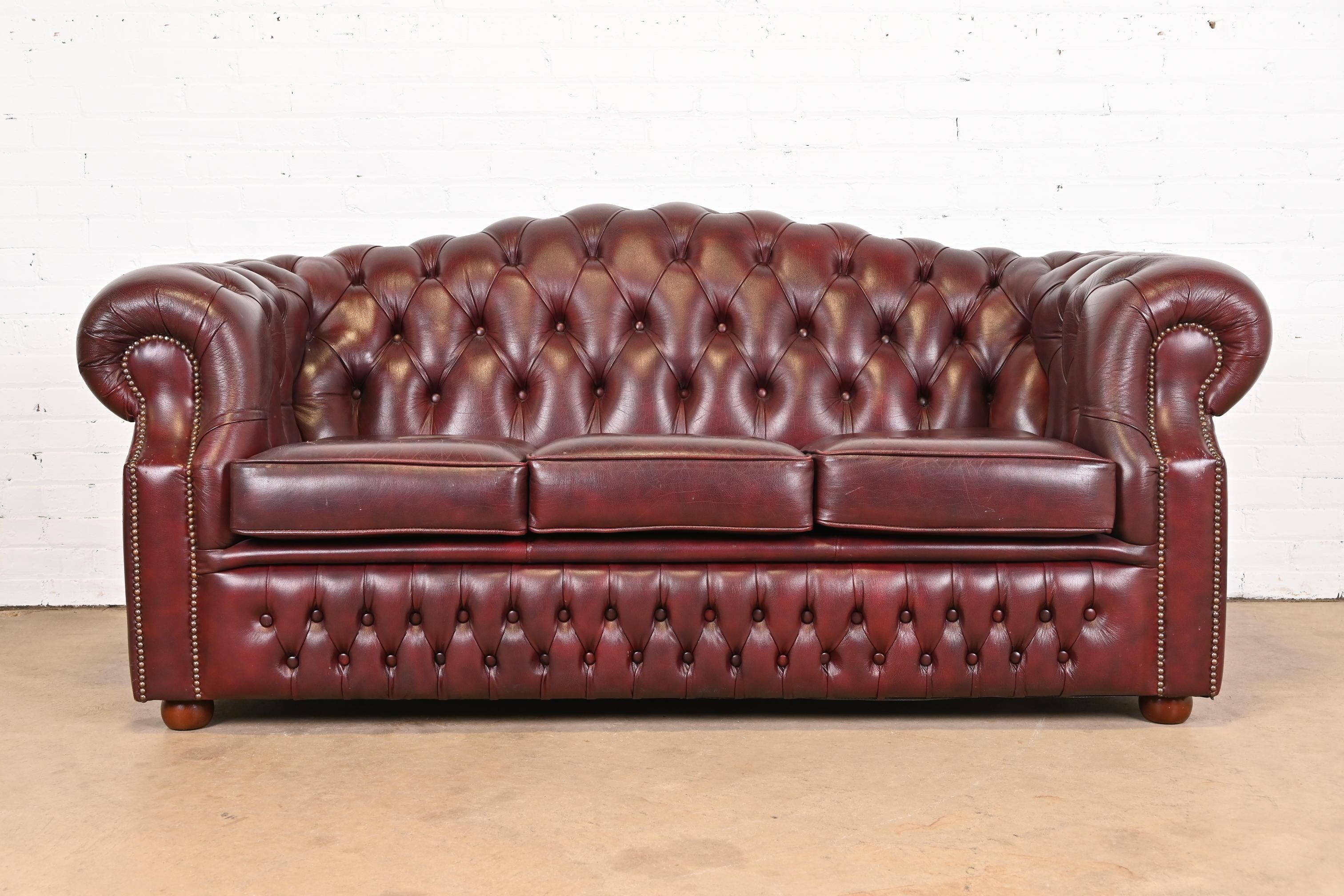 Vintage English Tufted Oxblood Leather Camelback Chesterfield Sofa In Good Condition In South Bend, IN