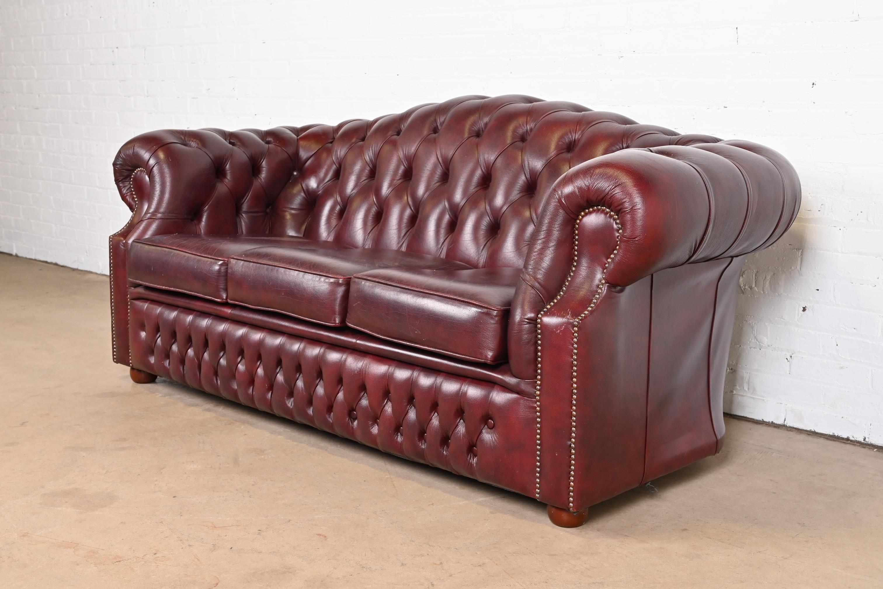 20th Century Vintage English Tufted Oxblood Leather Camelback Chesterfield Sofa