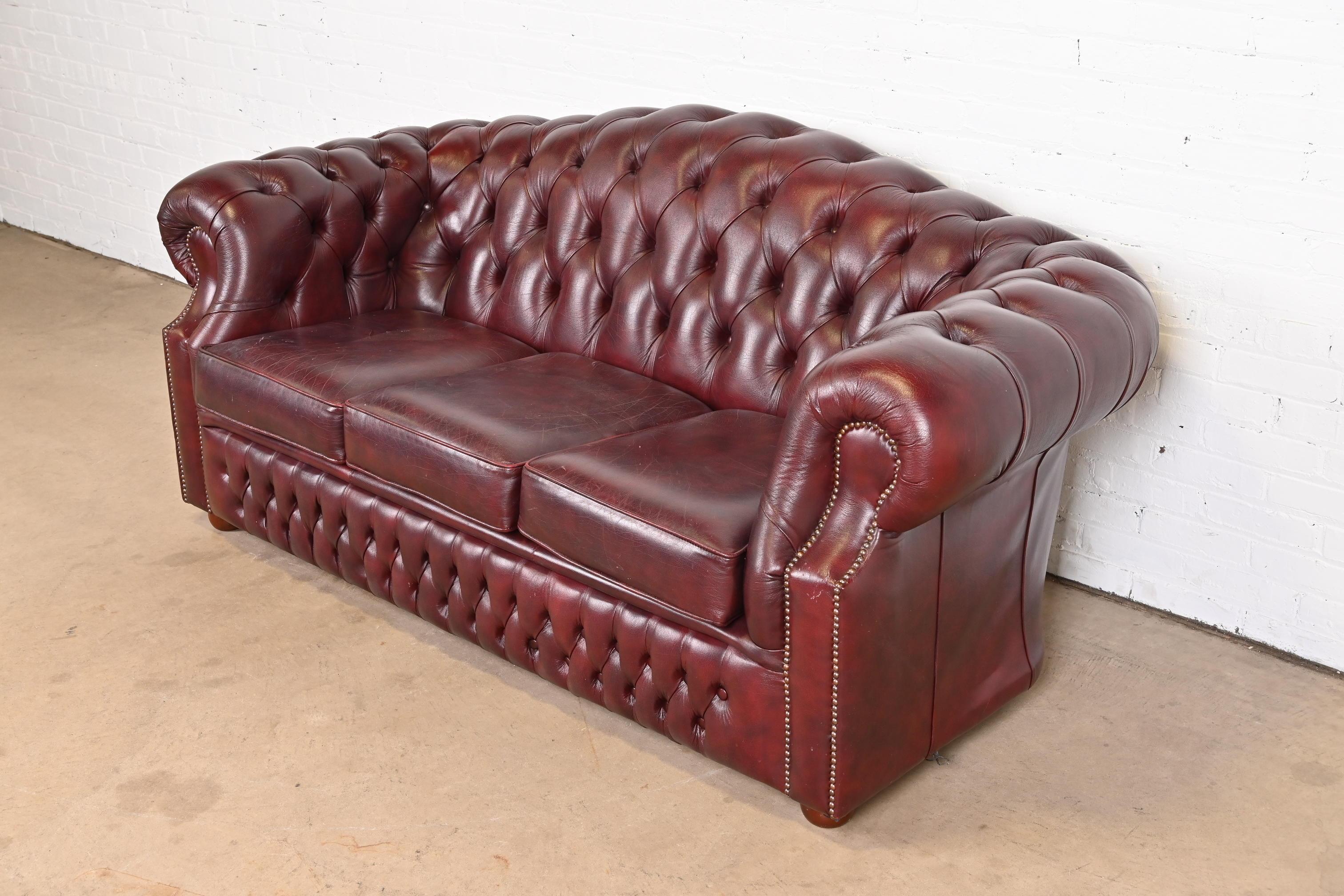 Brass Vintage English Tufted Oxblood Leather Camelback Chesterfield Sofa