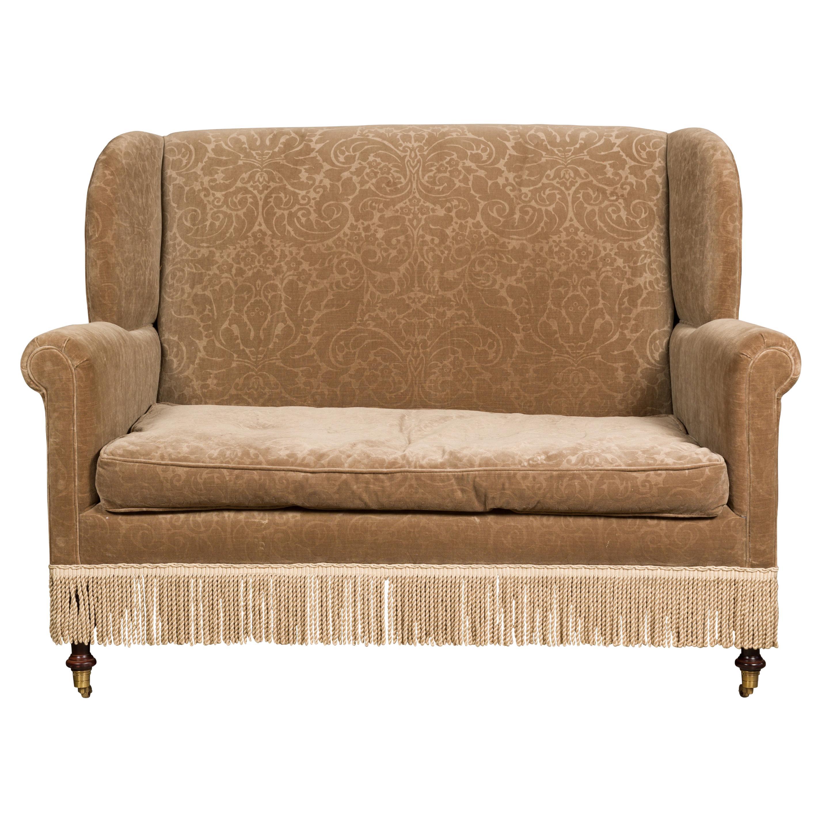 Vintage English Upholstered Loveseat with Out-Scrolling Arms and Casters For Sale