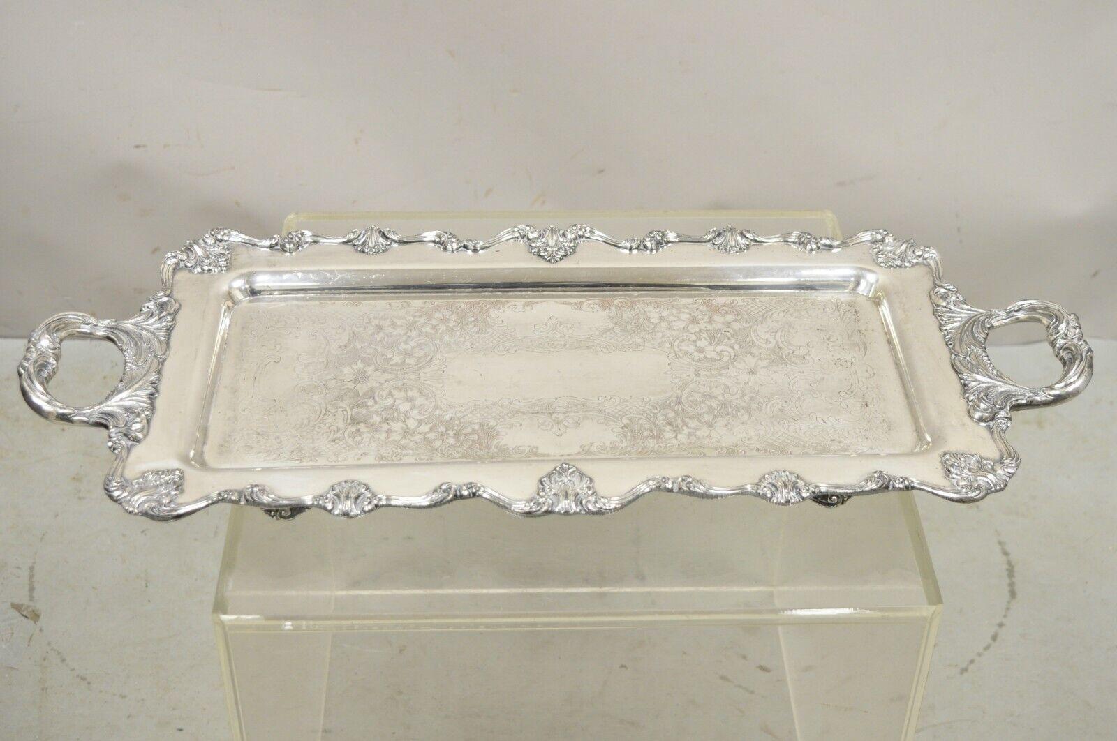Vintage English Victorian Narrow Silver Plate Twin Handle Serving Platter Tray. Item features ornate leafy scroll twin handles, nice narrow form, original hallmark. Circa Early to mid 20th century. Measurements:  1.5