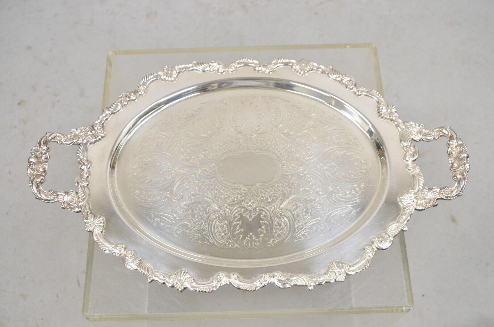 Vintage English Victorian Style Silver Plated Oval Platter Tray Crown Hallmark. Item featured is raised on ornate feet, etched center, original hallmark, very nice vintage item. Circa Mid 20th Century. Measurements:  2