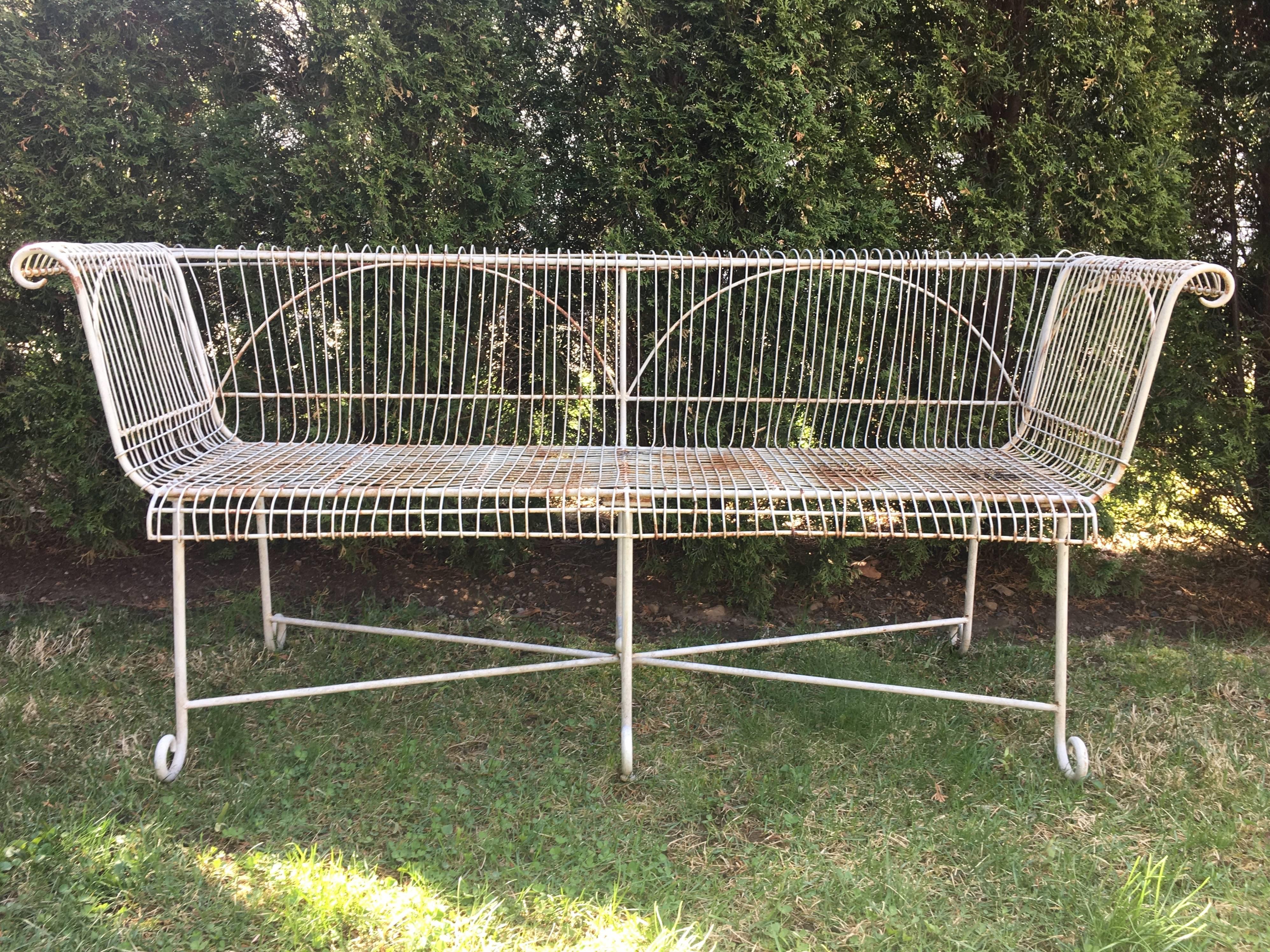 The form of this bench is truly sensational and although it reads white in color in the photos, it is actually a very pale sage green. Commodious and comfortable, it would be perfect in a contemporary or classical garden placed against a wall of
