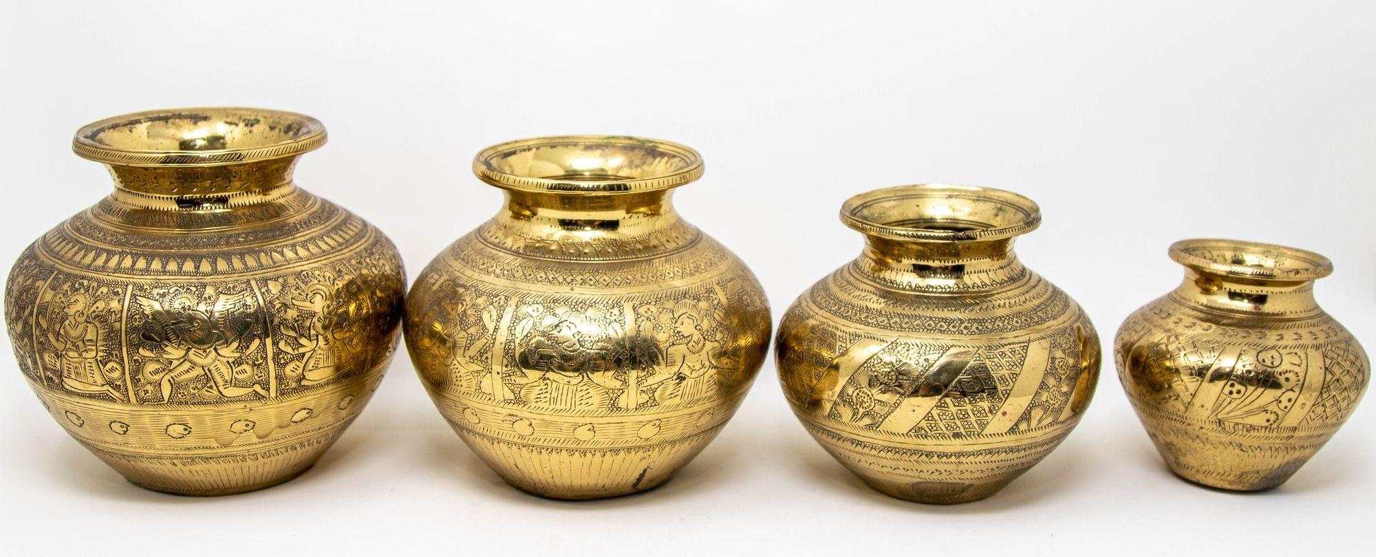 Add a touch of India's rich heritage to your home with this vintage set of four engraved brass lota from India, circa 1950s.
Hand-crafted from high-quality brass and adorned with intricate engravings, these antique vessels showcases traditional