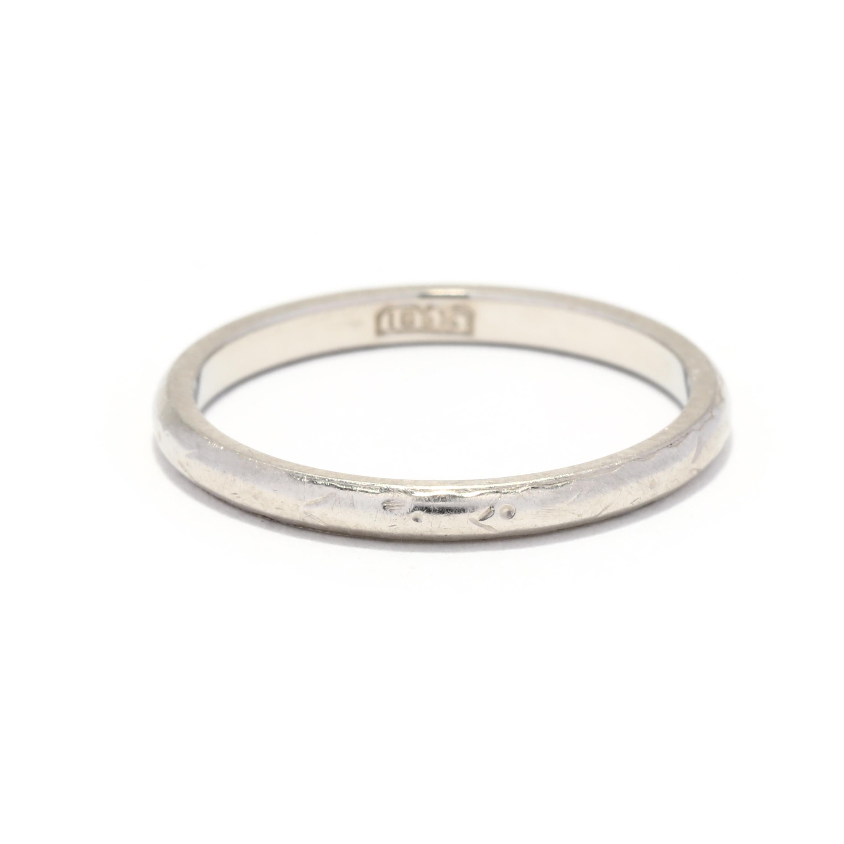 An antique 18 karat white gold engraved wedding band. This thin band features a lightly engraved floral band in an eternity design.

Ring Size 5.25

Width: 2 mm

Weight: 1.2 dwts.

Ring Sizings & Modifications:
*Please reach out before your purchase