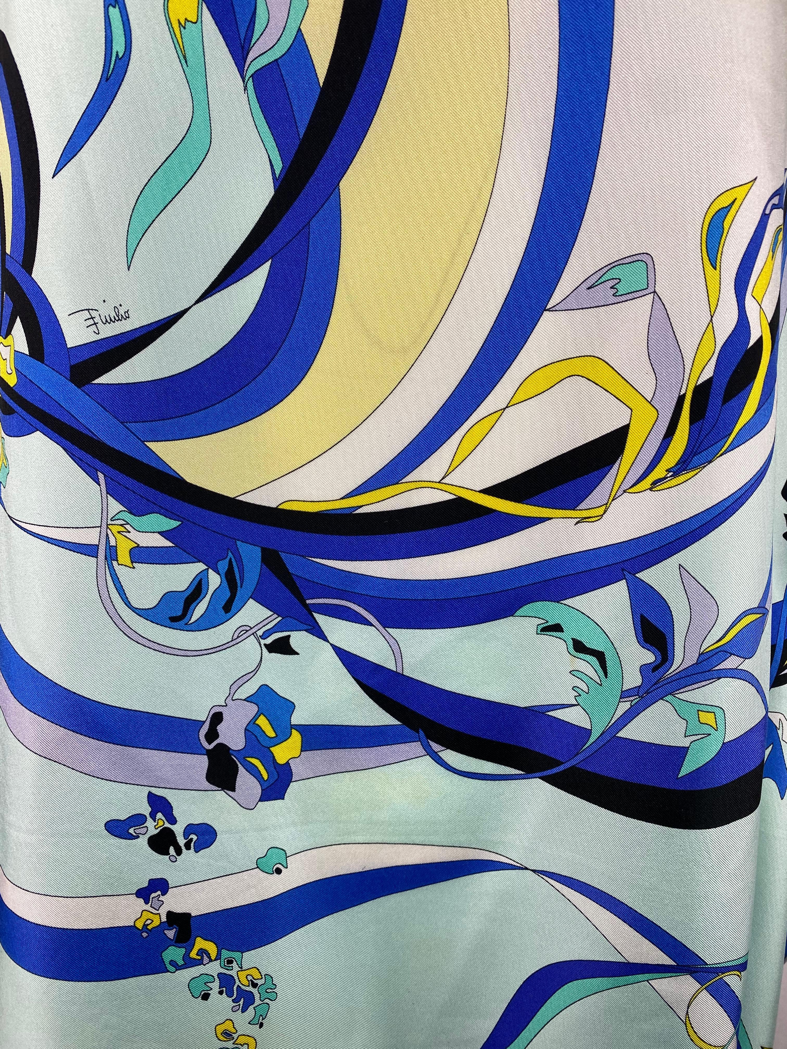 Product details:

The top features yellow and blue 100% silk with floral and geometric print. It can be styled as a cover up at the beach or it can be casually styled with the jeans. Made in Italy.