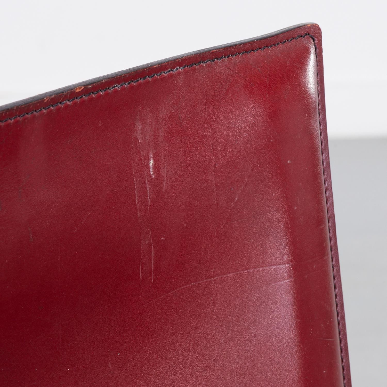 20th c., Italy, Enrico Pellizzoni oxblood saddle-stitched leather over metal frame and seat. These chairs were designed by Grassi & Bianchi. An embossed leather mark is present on the underside of each chair.

The Enrico Pellizzoni brand was created