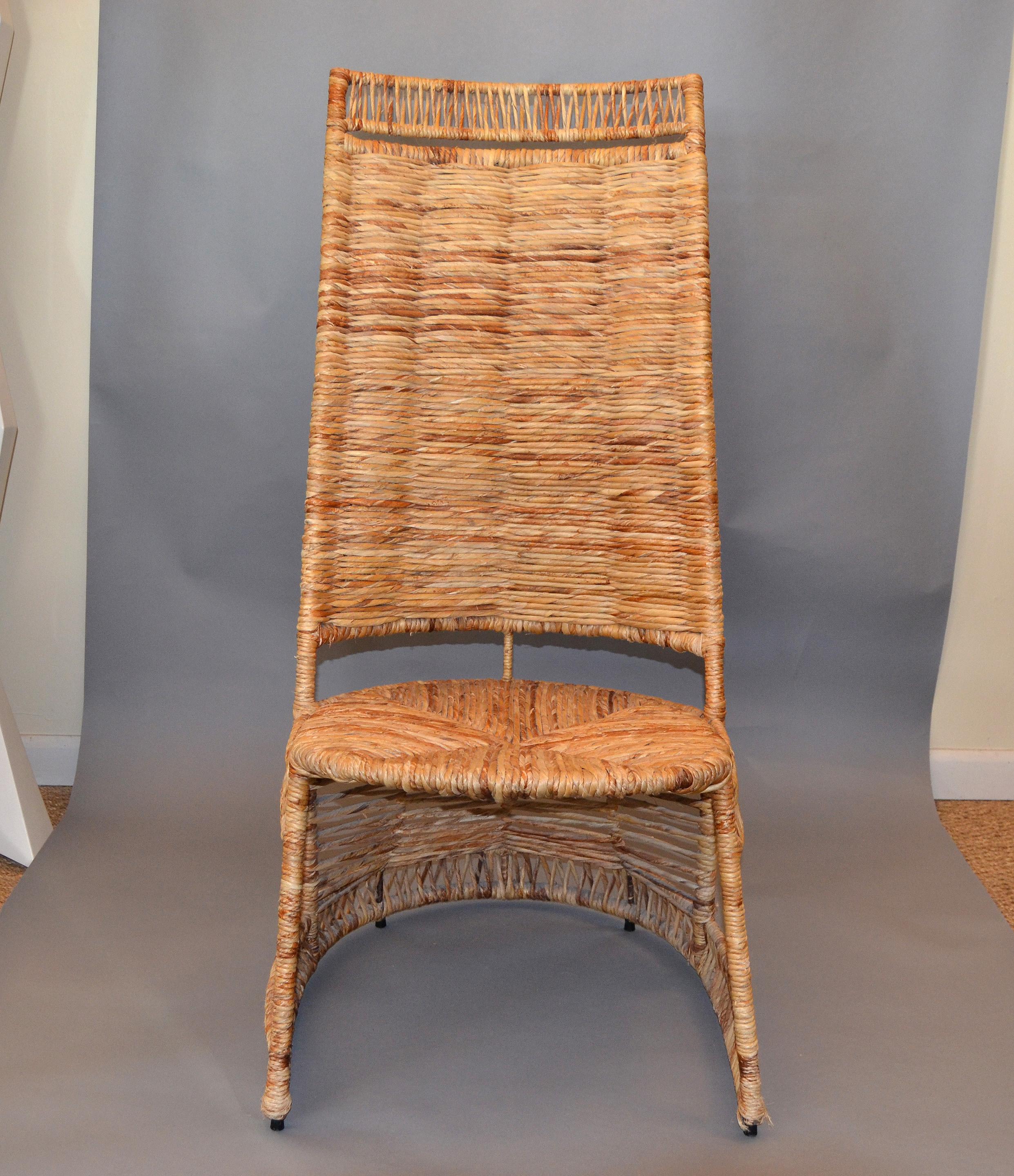 This side chair is one of a kind. 
It has a metal core and is entirely handwoven with strand cane and rattan reed. 
The woven rush seat and the sculptural base is stunning.
The chair is very comfortable and can be used as a reading chair or for