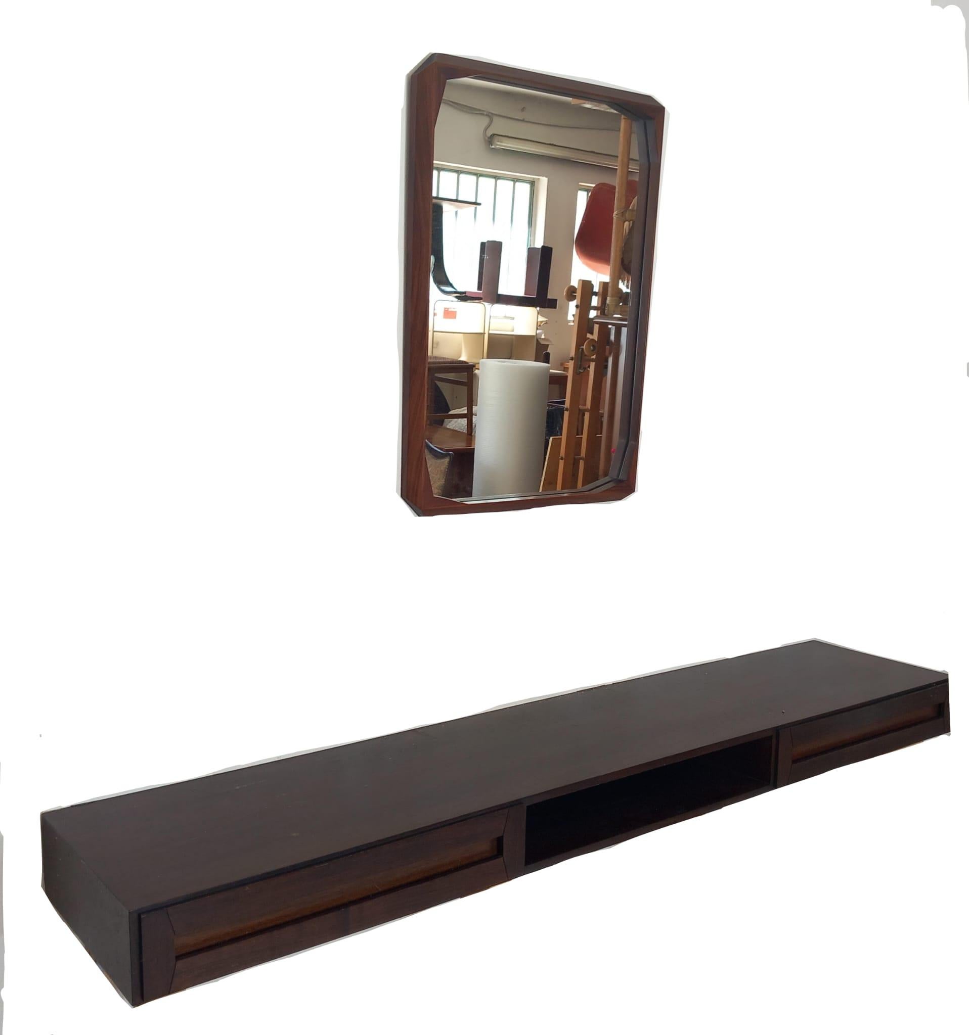 Bring timeless character to your home with this vintage set for the entryway, composed of a wall-mounted console and matching mirror, designed and produced in the 1960s. Crafted in wood with a warm tone, the set features simple, clean, geometric