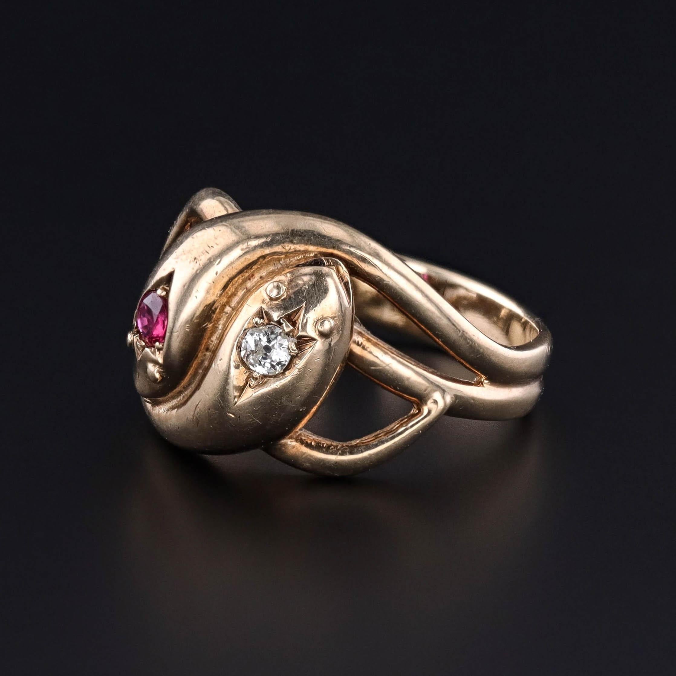 This 9ct gold ring (dated 1982) features an entwined snake design, adorned with a natural, untreated ruby and an old European cut diamond.

The ring bears hallmarks indicating that it was assayed in Birmingham, England.  It weighs 8.78 grams and is