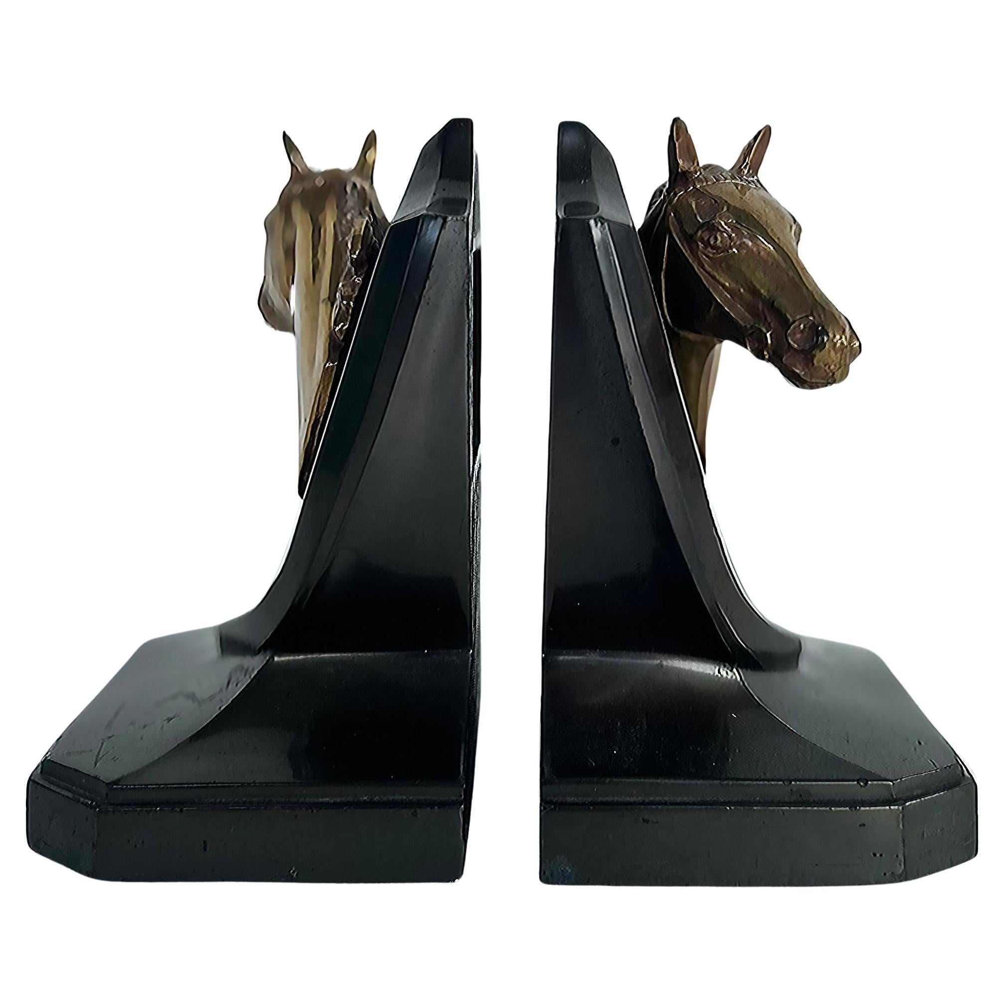 Vintage Equestrian Horse Iron, Brass Trophy Bookends Stamped P.M.C, Pair

Offered for sale is a pair of equestrian-themed iron and brass trophy bookends stamped P.M.C. . Each bookend features a gold-tone horse's head mounted on a black shield rising
