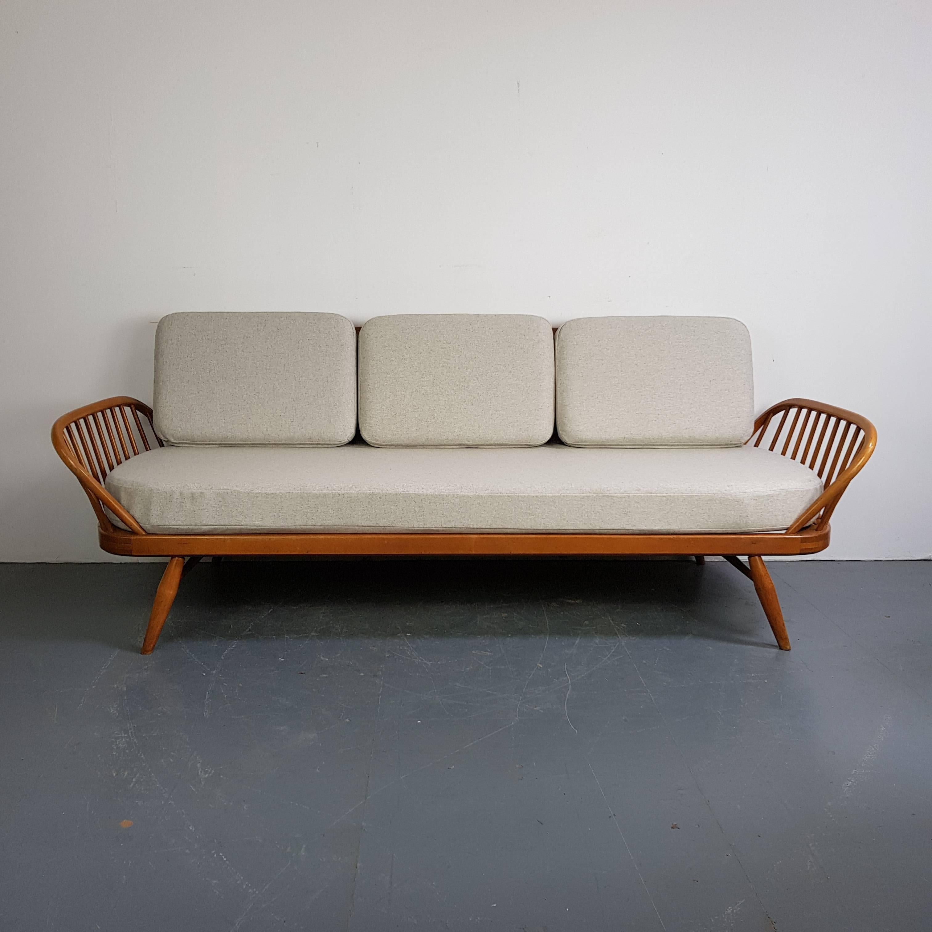 Refurbished vintage Ercol 355 studio couch or sofa bed.

Inspired by Scandinavian design, the Studio couch was designed by Lucian Ercolani in 1958 and manufactured by Ercol in the 1960s-1970s. 

This is the blonde (beech) model.

The cushions