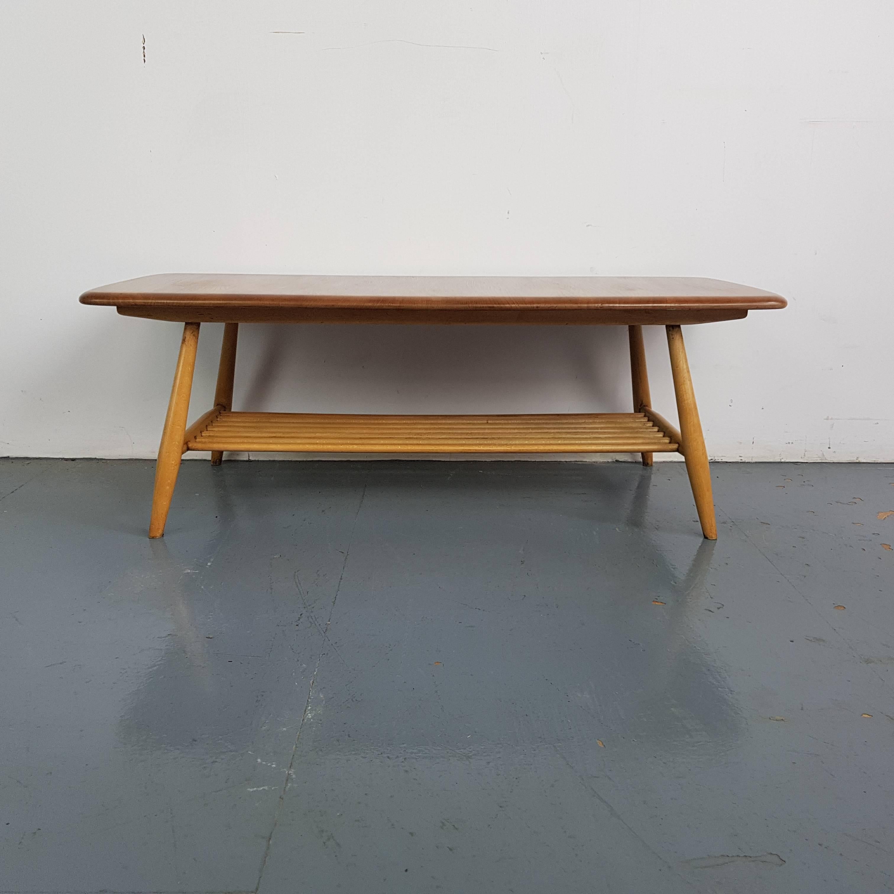 Designed by Lucian Ercolani, these Ercol tables echo design features in the Windsor range with its rounded edges.  It has a beech top and splayed tapering legs plus magazine rack underneath.  Lovely patina to the wood. 
In good vintage condition,