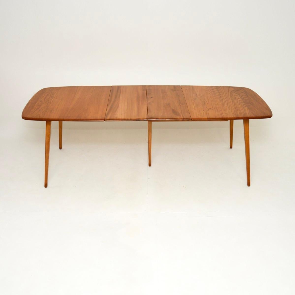 A beautiful and iconic vintage Ercol Grand Windsor dining table in solid elm. This was made in England, it dates from the 1960’s.

This of outstanding quality, as with all Ercol products, and it is beautifully designed. This is a very impressive