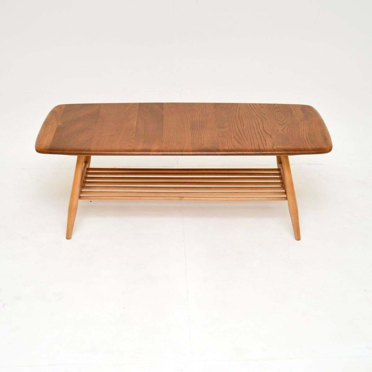 A stunning vintage Ercol Windsor coffee table, made in England and dating from around the 1960-70’s.

As with all Ercol products it is extremely high quality. It is a lovely size, with a useful lower tier for extra storage.

The top is solid elm,