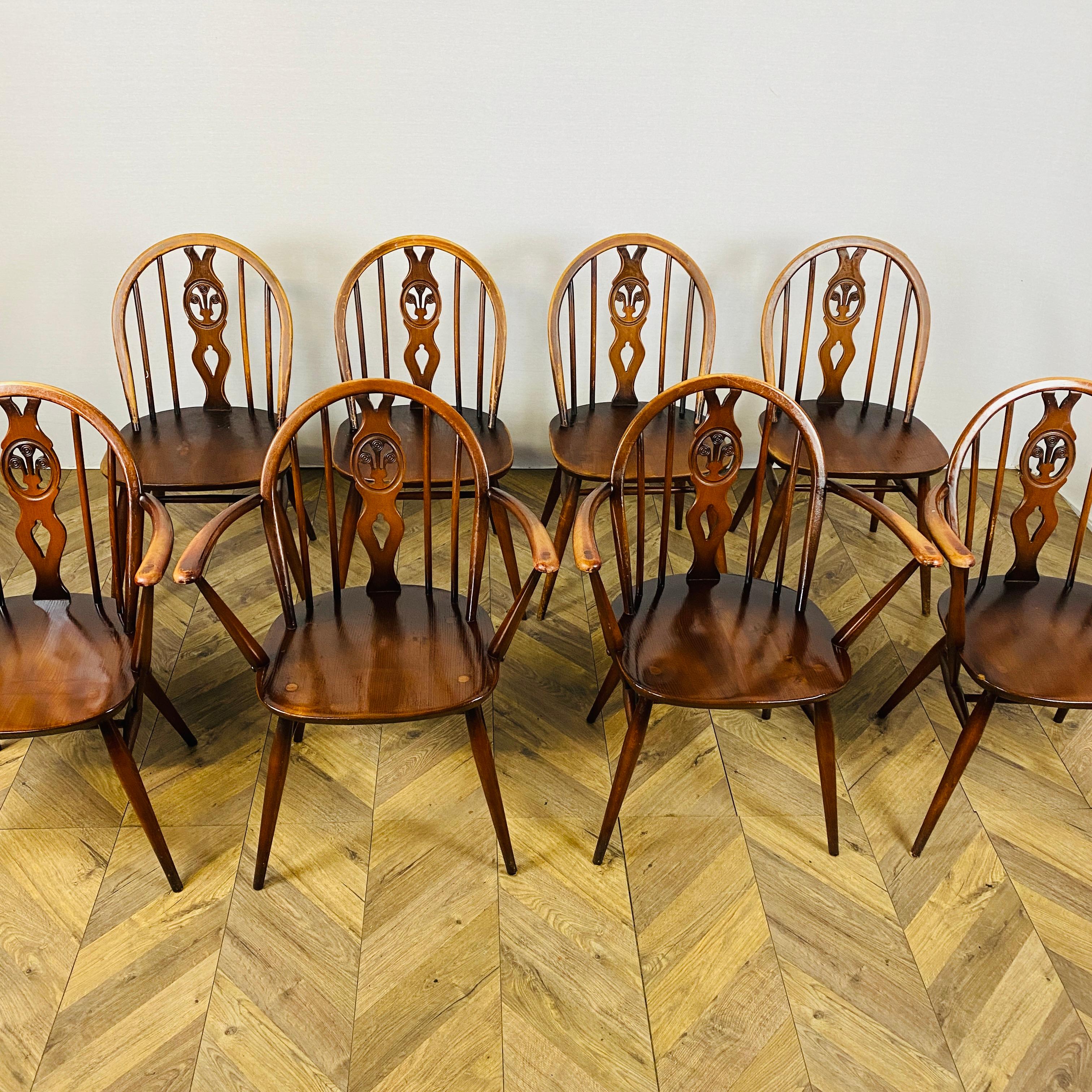 Set of 8, Ercol Windsor Fleur De Lys Chairs, 1960s.

Designed by Lucian Ercolani, the Fleur De Lys chairs seamlessly blend contemporary British design and traditional craftsmanship. 

The chairs are made from solid beech with elm seats and boast