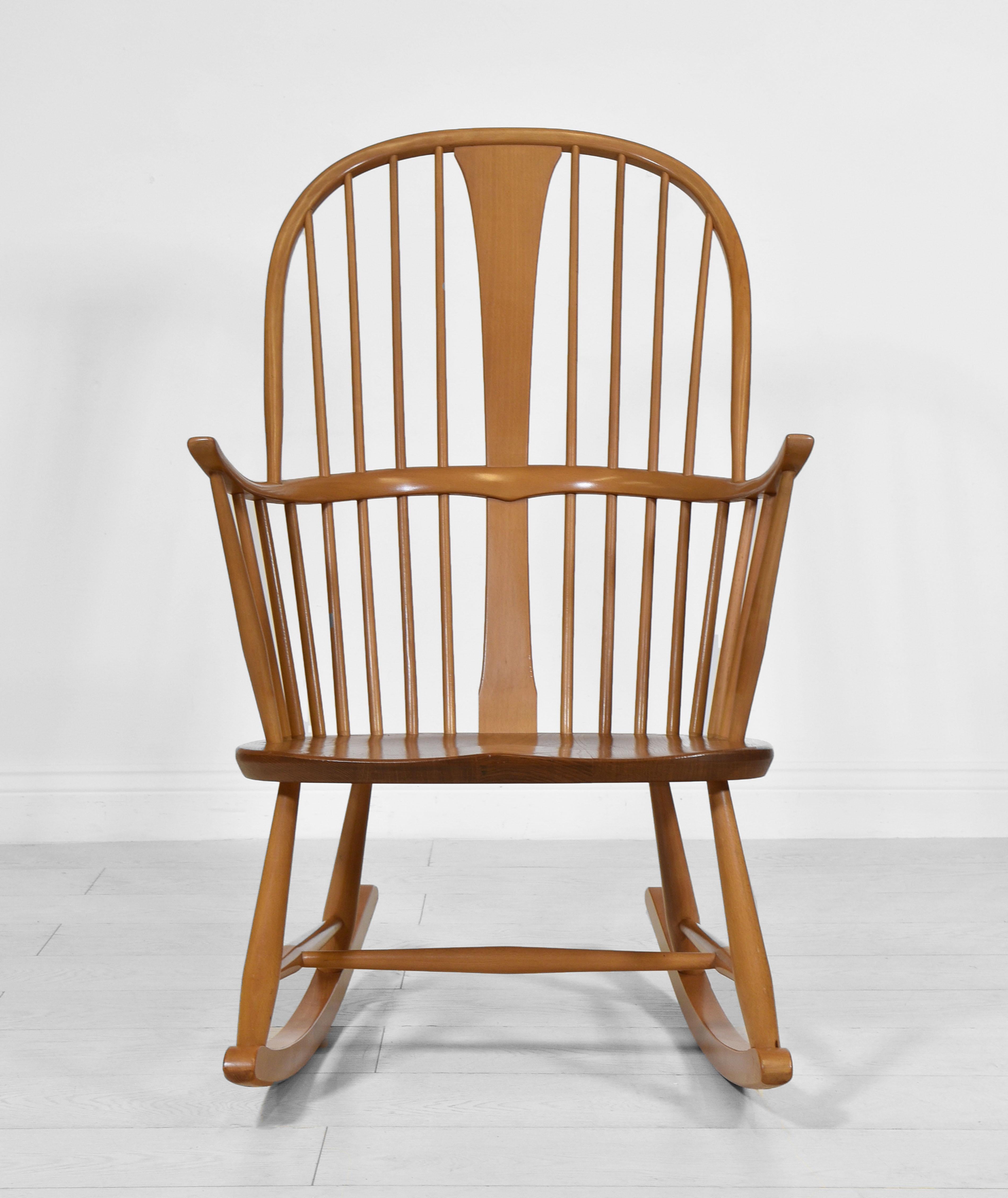 A vintage Ercol Windsor double bow rocking chair, designed by Lucian Ercolani and launched in 1962. Blue foil maker's label. Circa 1970.

Showing all the quality craftsmanship used by this company, the rocking chair has its original finish, which