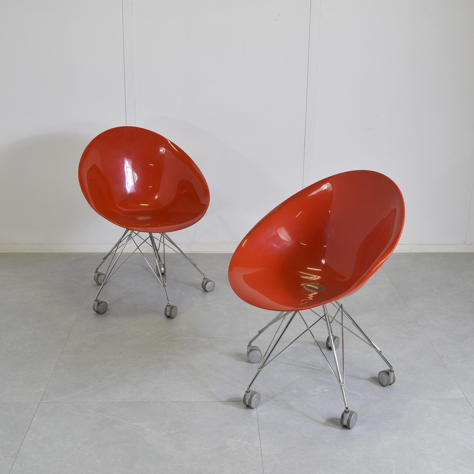 Pair of chairs model Eros made of polycarbonate and die-cast metal, Designed by Philippe Starck in 1995 for Kartell, Eros is an enveloping, organically shaped armchair characterized by a refined combination of finishes and a skillful use of