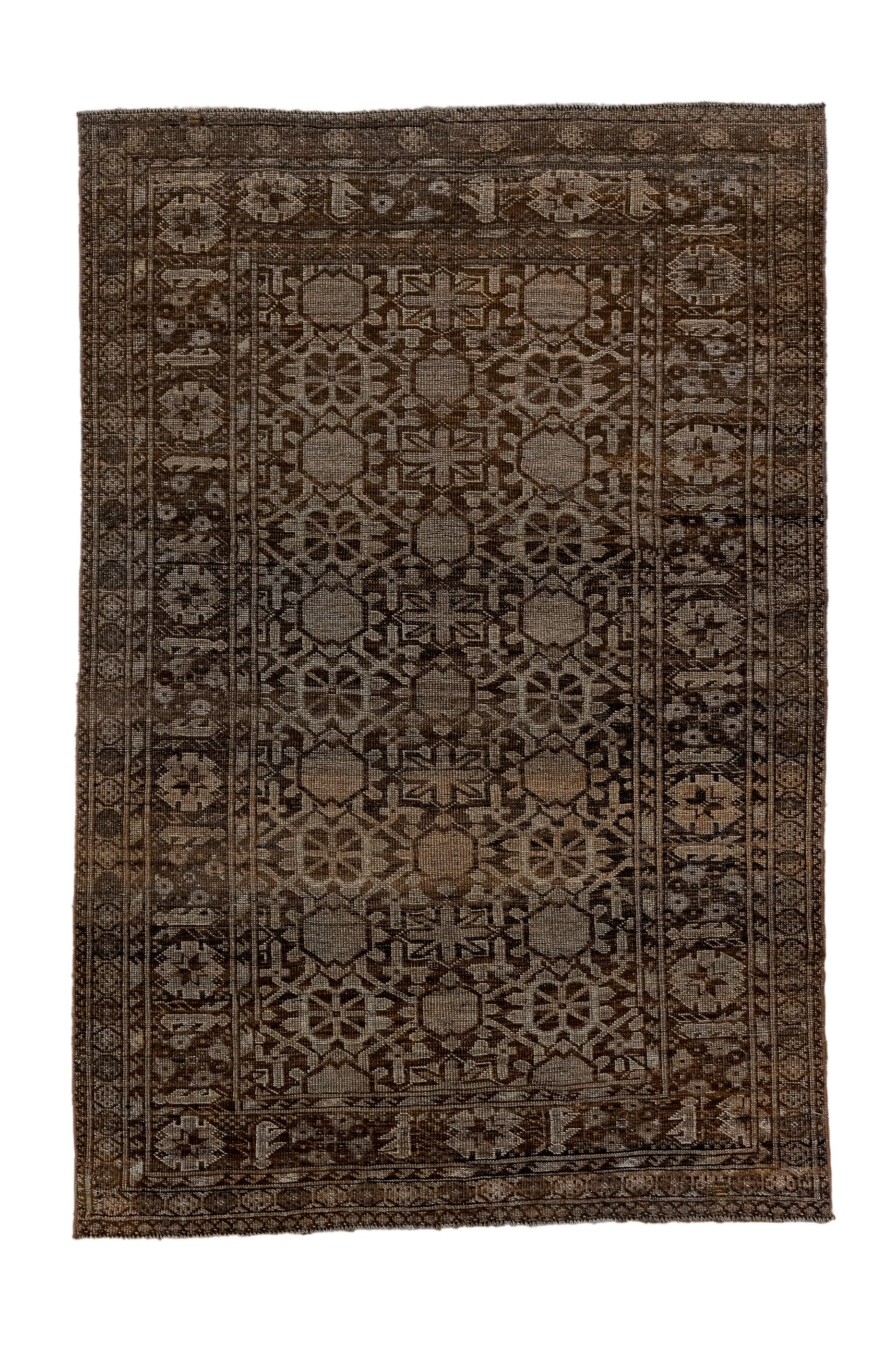 The Minas Khani floral rosette trellis is here interpreted in a more geometric, frozen manner, on the dark brown ground. The brick border shows notched, geometric rosettes and stiff formal leaves. Wool construction, moderate weave, generally good