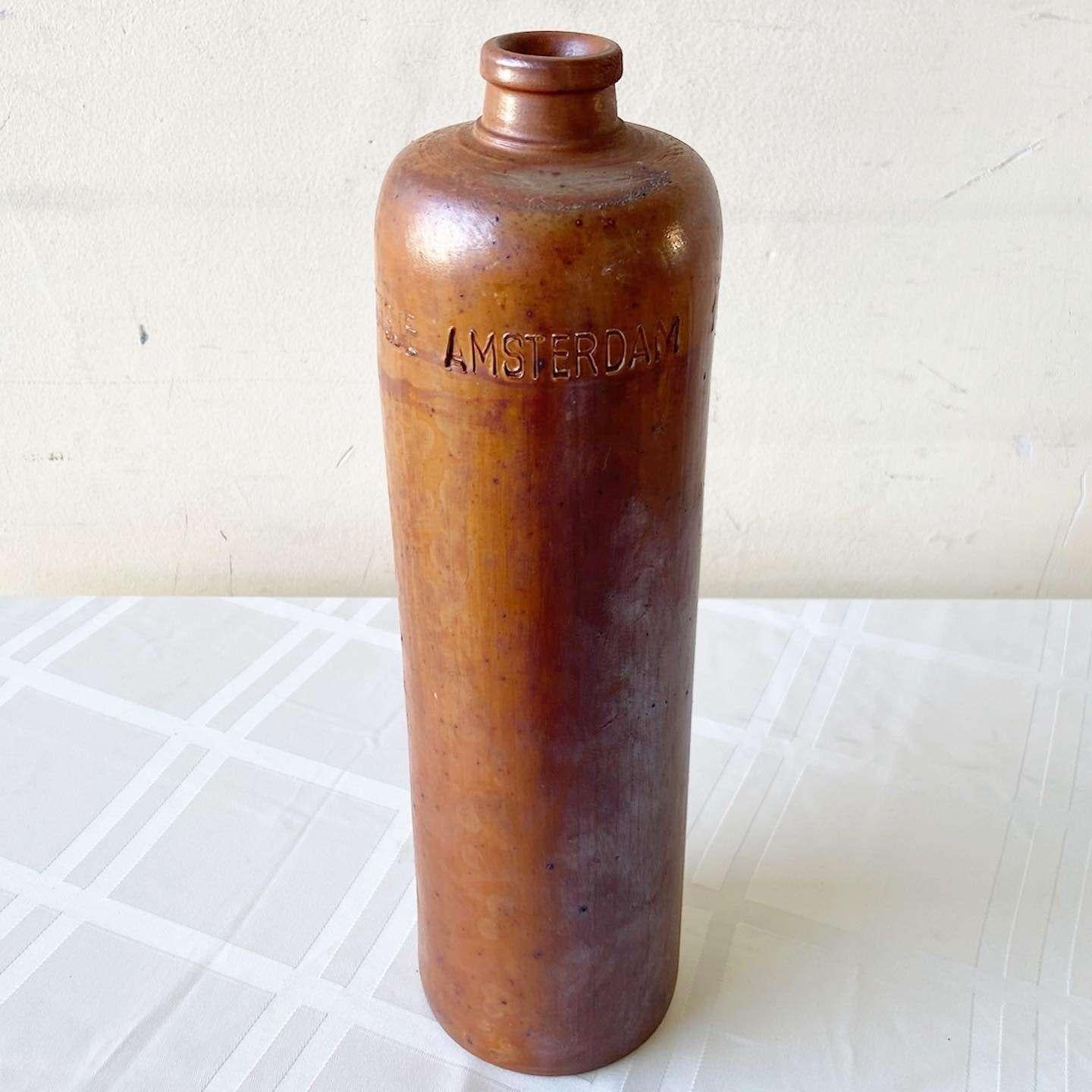Exceptional clay bottle from Amsterdam by Erven Lucas. Features a browned clay tone with its capacity, maker and place of origin carved into the sides. 1 liter
