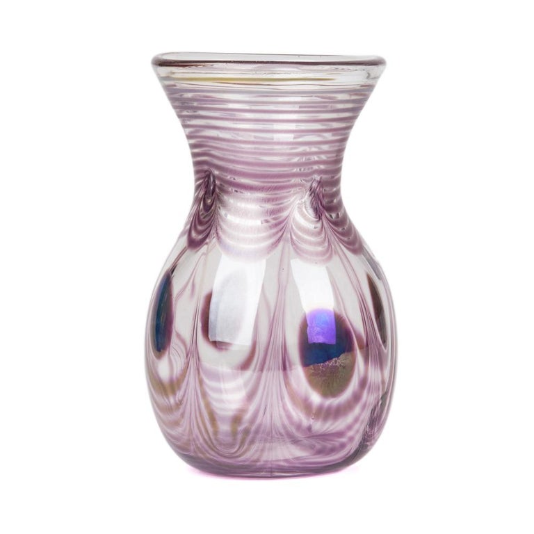 A stylish German art glass vase in the shape of a hyacinth vase and decorated with peacock feather designs with metallic lustres to elements of the design. The hand blown vase has an Eisch signature to the base and is dated 1987.
German, Erwin