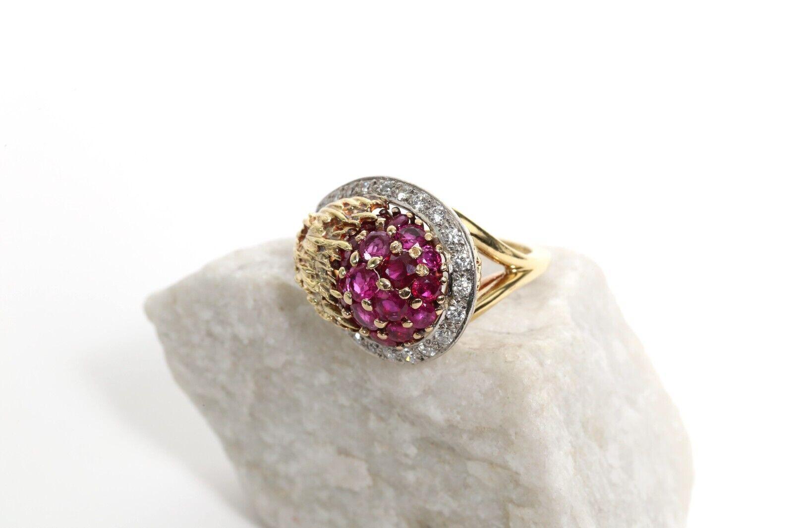 This vintage asymmetrical ring is crafted by the fine jewelry designer Erwin Pearl. Crafted in a rich 18k gold, the ring features Erwin Pearl’s known textured gold designs accenting the prong set pave style rubies in the center. Circling the domed