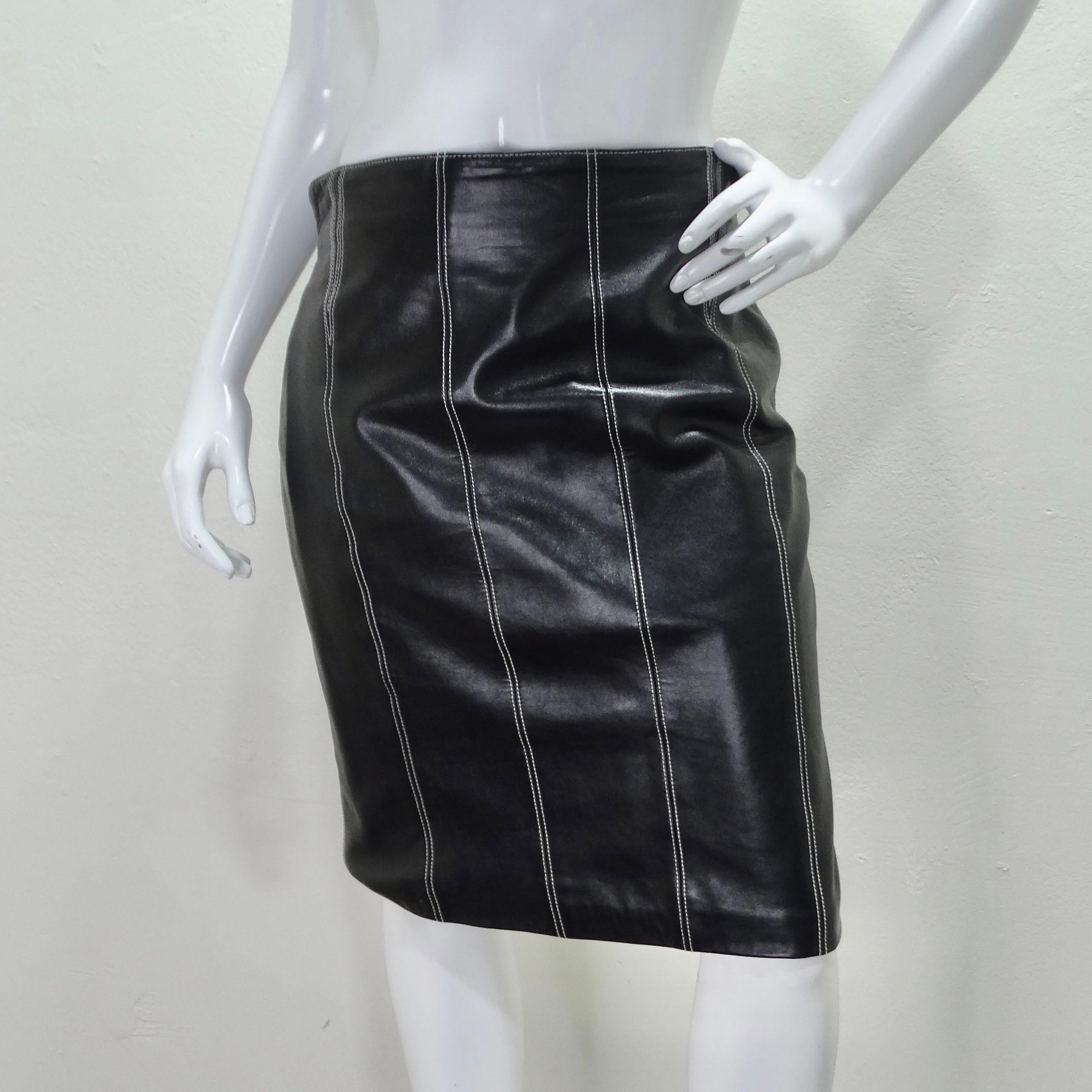 Your next go-to skirt is calling your name! This 1990s Escada pencil skirt is so classic and versatile. Classic mid length pencil skirt is compromised of a soft black leather with contrasting decorative white stitching. Featuring a full lining and