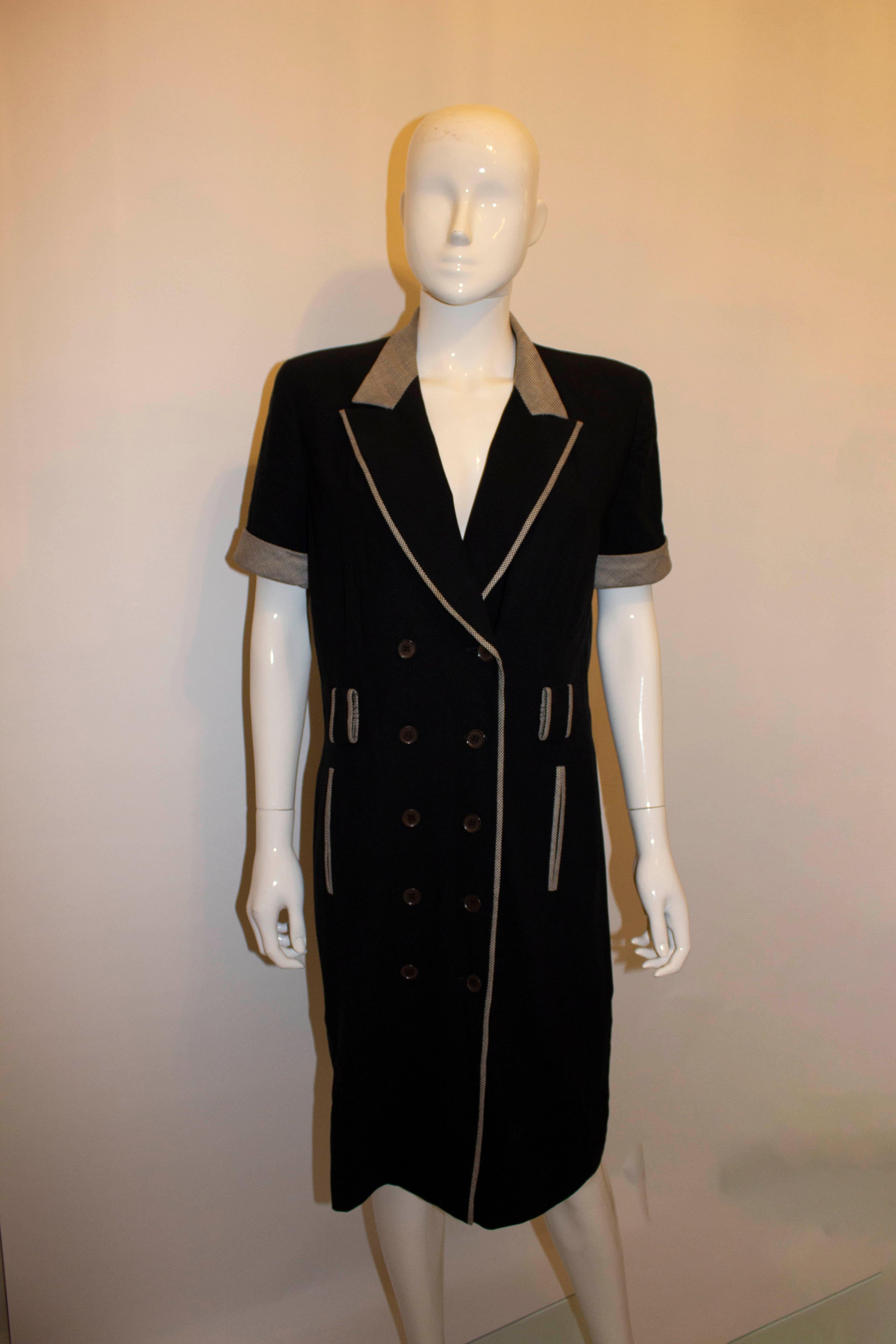 A chic vintage shirt dress by Escada for Margaretha Ley. The dress is double breasted, with turn back cuffs and shoulder pads. It is fully lined. Size 36 Measurements: Bust 37'', length 42''