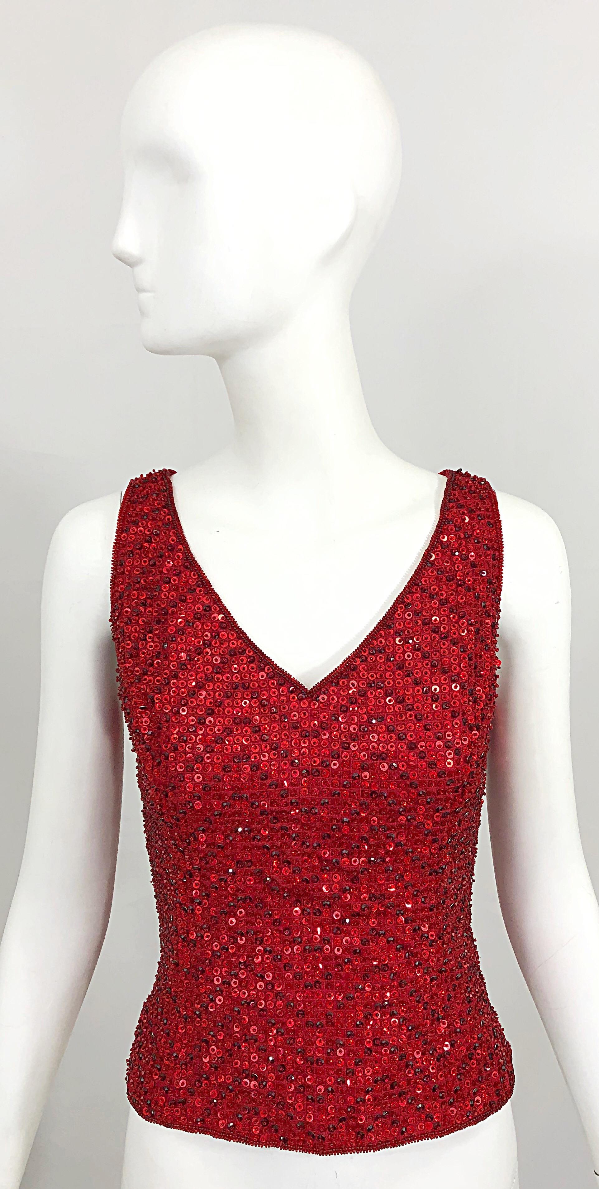Chic vintage ESCADA COUTURE lipstick red silk sequined and beaded sleeveless blouse! Features thousands of hand-sewn sequins and beads throughout the entire top. Hidden zipper up the side with hook-and-eye closure. Can easily be dressed up or down,