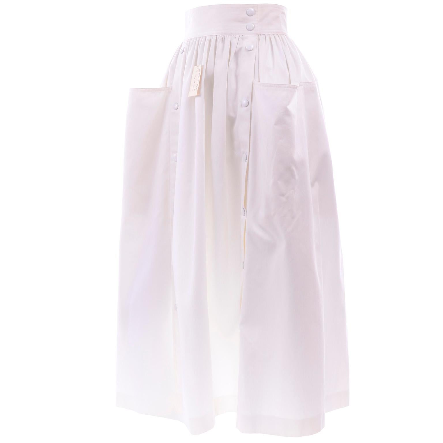 This is an unworn vintage Escada white cotton skirt with front snaps and pockets.  The skirt still has its original tags and is marked a European size 34.  We estimate it to fit a modern day US size 4.  

WAIST: 24