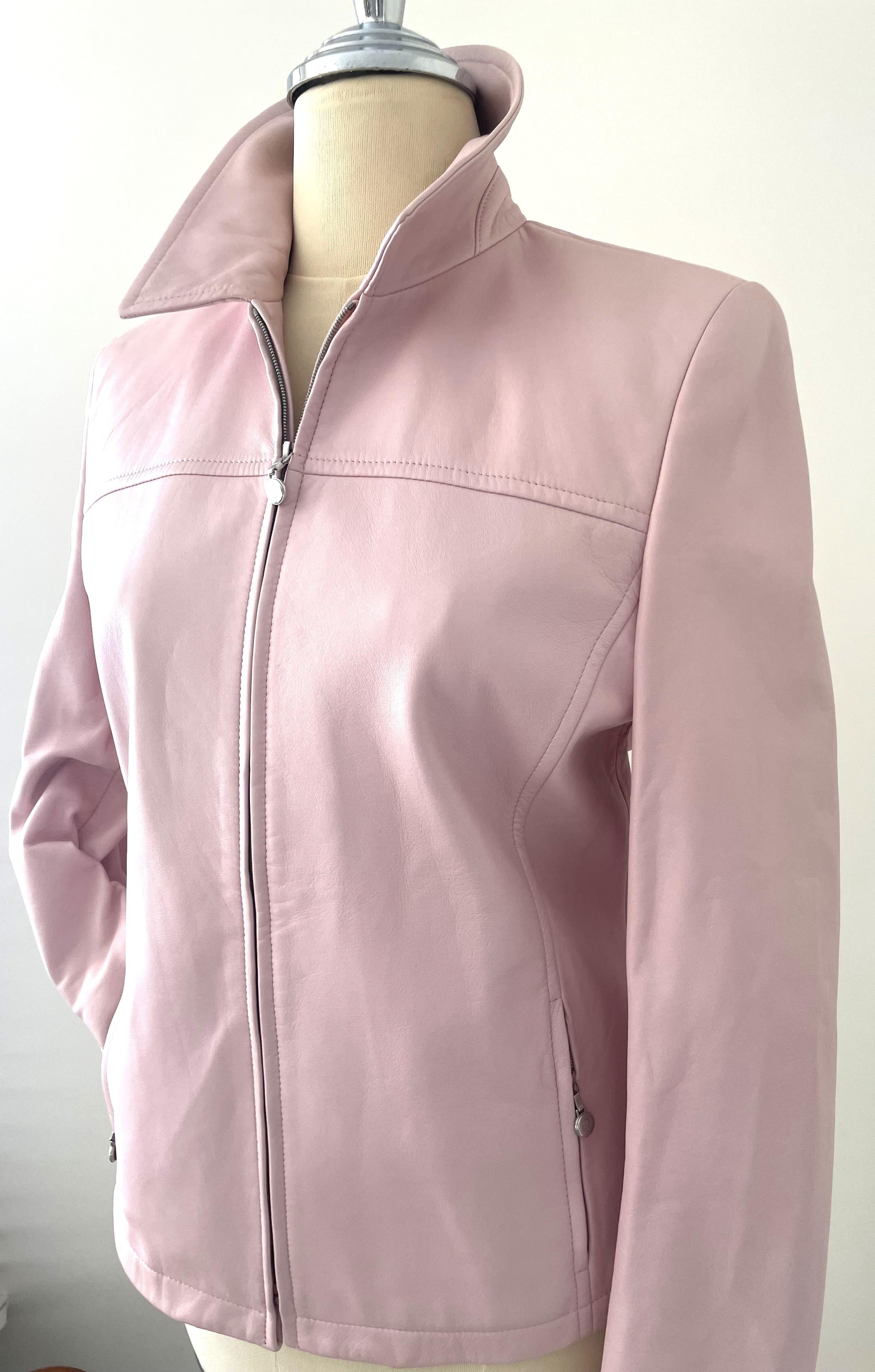 The Escada leather short jacket in light pink from the 90s is a fashionable vintage piece that reflects the style and trends of that era. Escada is a luxury fashion brand founded in 1978 by Margaretha and Wolfgang Ley, known for its high-quality