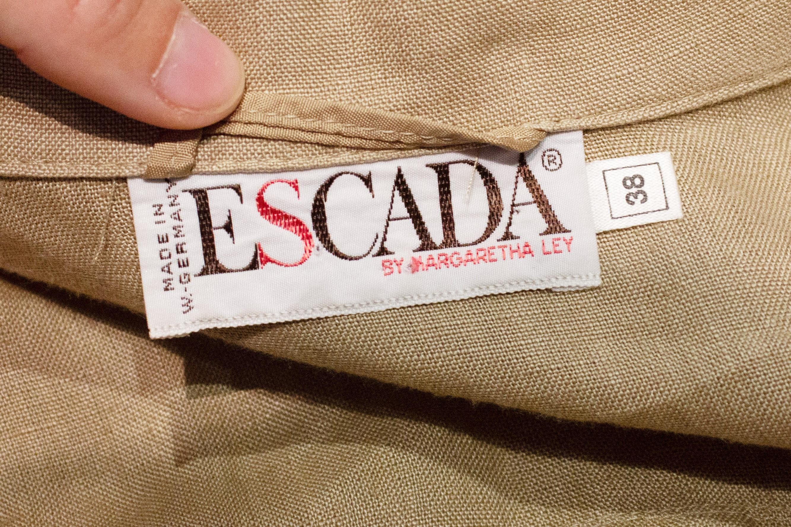 Una grande annata  Camicia/giacca di  Escada. In lino pesante, presenta due interessanti tasche anteriori e un dettaglio di piega sul retro. La giacca ha un'apertura con bottoni sul davanti, polsini con un solo bottone e uno spacco di 8'' sul retro.
