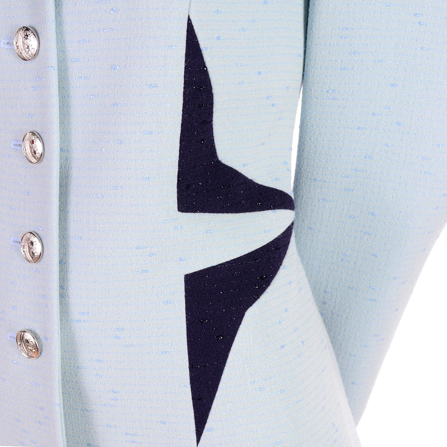 This is a rare Escada vintage blazer with geometric designs reminiscent of Thierry Mugler's style! This pale blue jacket has dramatic dark blue triangles at the waist and under the collar. The jacket is in a virgin wool blue fabric with nylon