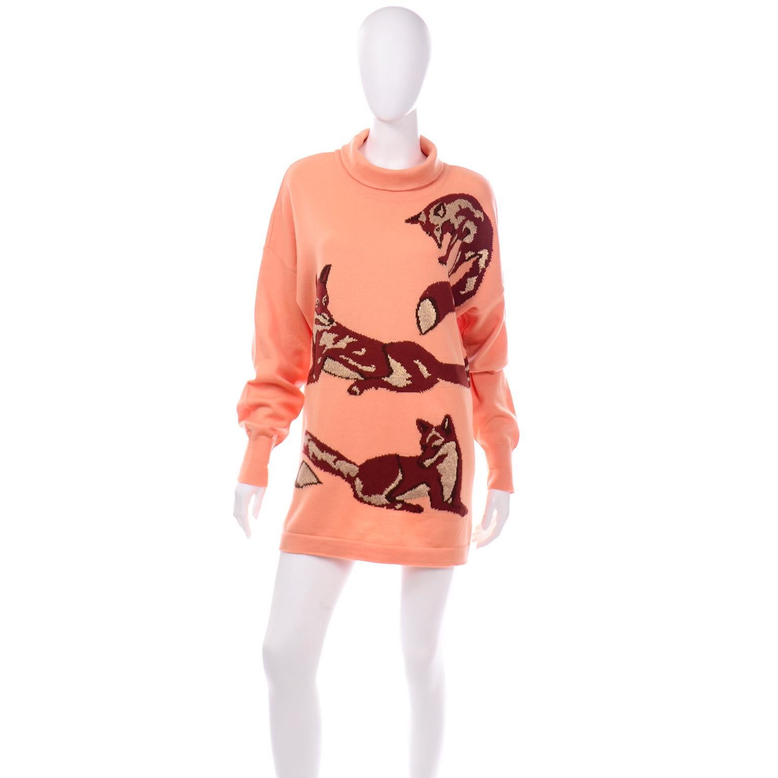 This is such an incredible vintage oversized Escada turtleneck sweater in a peach wool blend featuring playful brown foxes with gold metallic thread detail. You can even wear this as a mini dress!  The sweater has the older Escada by Margaretha Ley