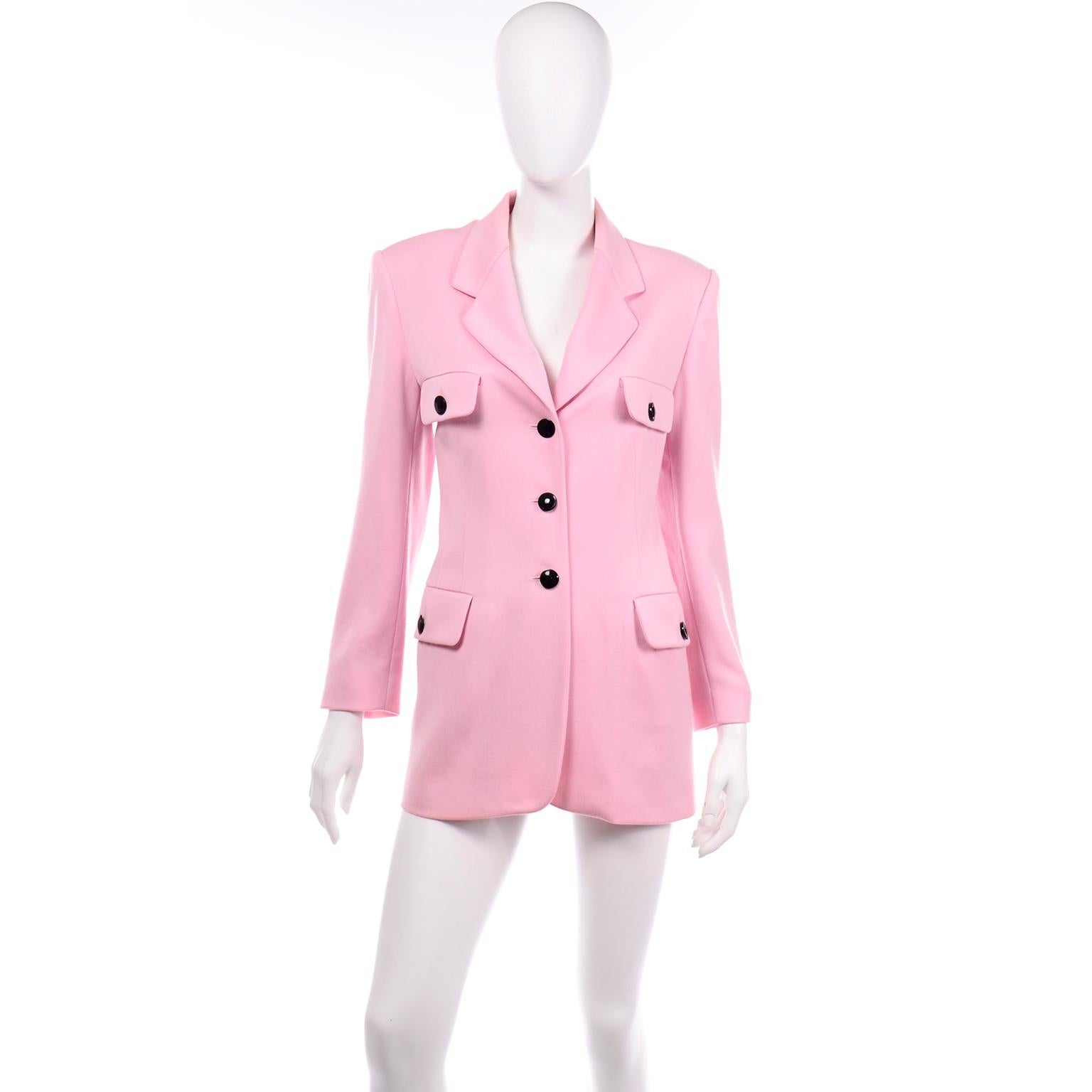 This absolutely beautiful vintage pink wool longline blazer was made designed by Margaretha Ley for Escada in the 1980's. This lovely jacket will carry you through the Spring and Summer! We love the contrast of the light pink wool with the black