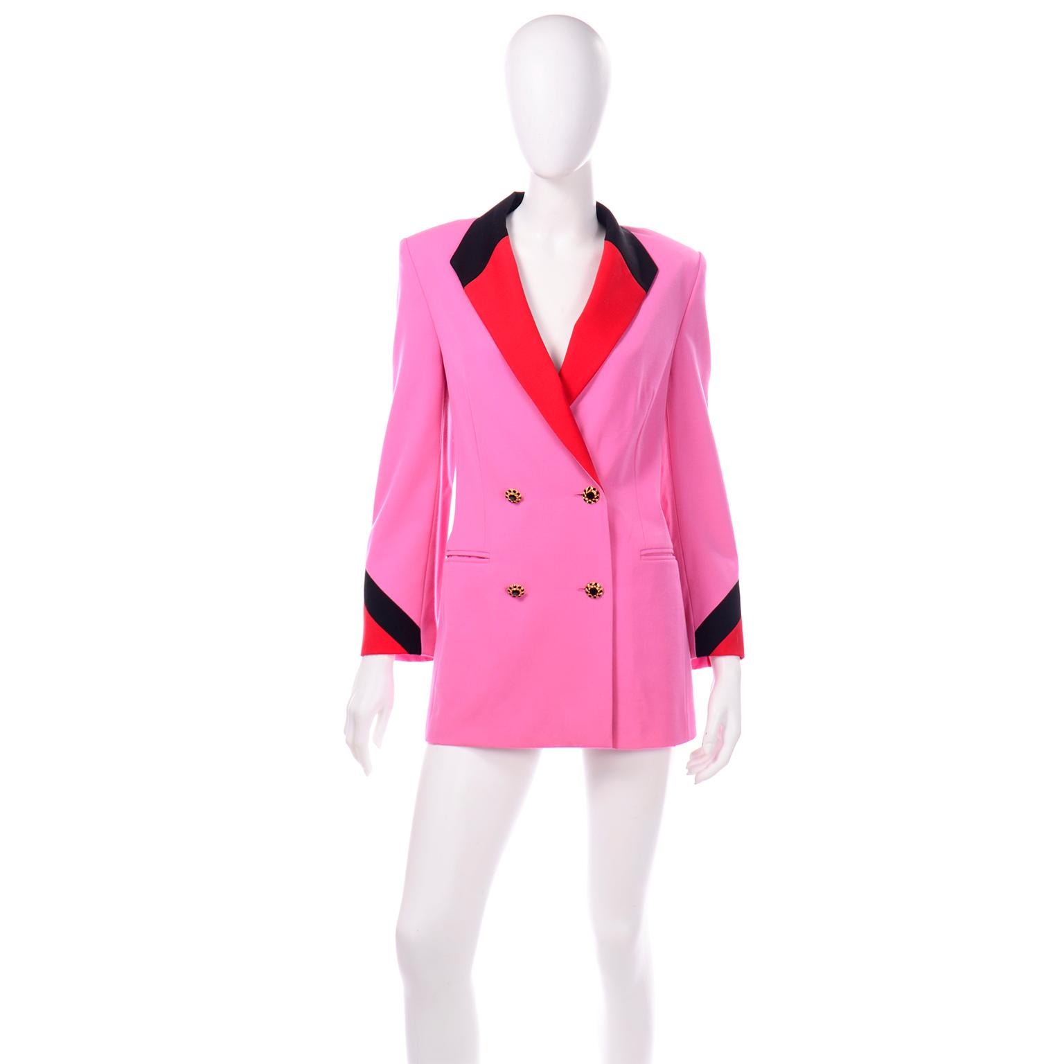 This vibrant 1980's Margaretha Ley Escada blazer is in a gorgeous pink Summer weight wool with red and black accent colors on the collar and cuffs. This longline double breasted blazer has unique gold and black rhinestone buttons on the front. The