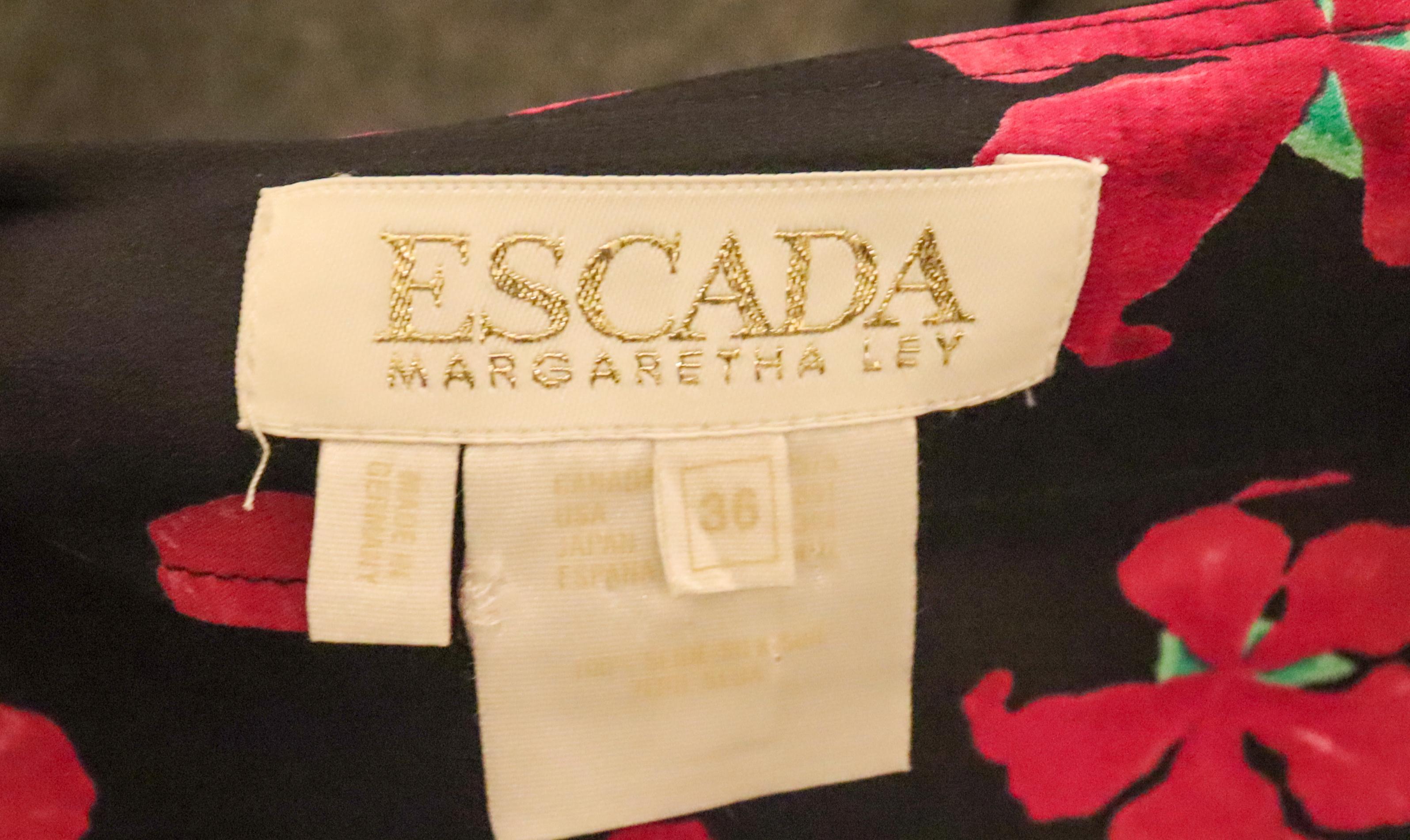 A wonderful vintage wrap silk skirt by Escada, Margaretha Ley. In a super soft silk , the skirt has a black background and pink floral print.
Made in Germany, Size 36  Measurements; Wasit 28'', length 40''