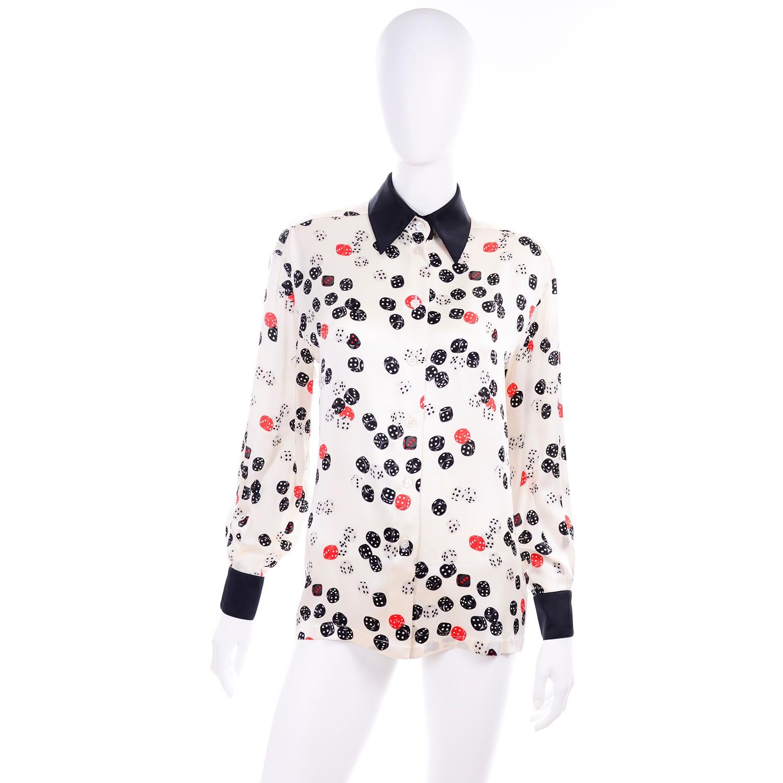 This is another fabulous vintage Escada silk blouse designed by Margaretha Ley. Escada prints are always some of our favorites and this one is no exception. This silk top has black cuffs, a black collar, and the fabric is a red, white and black